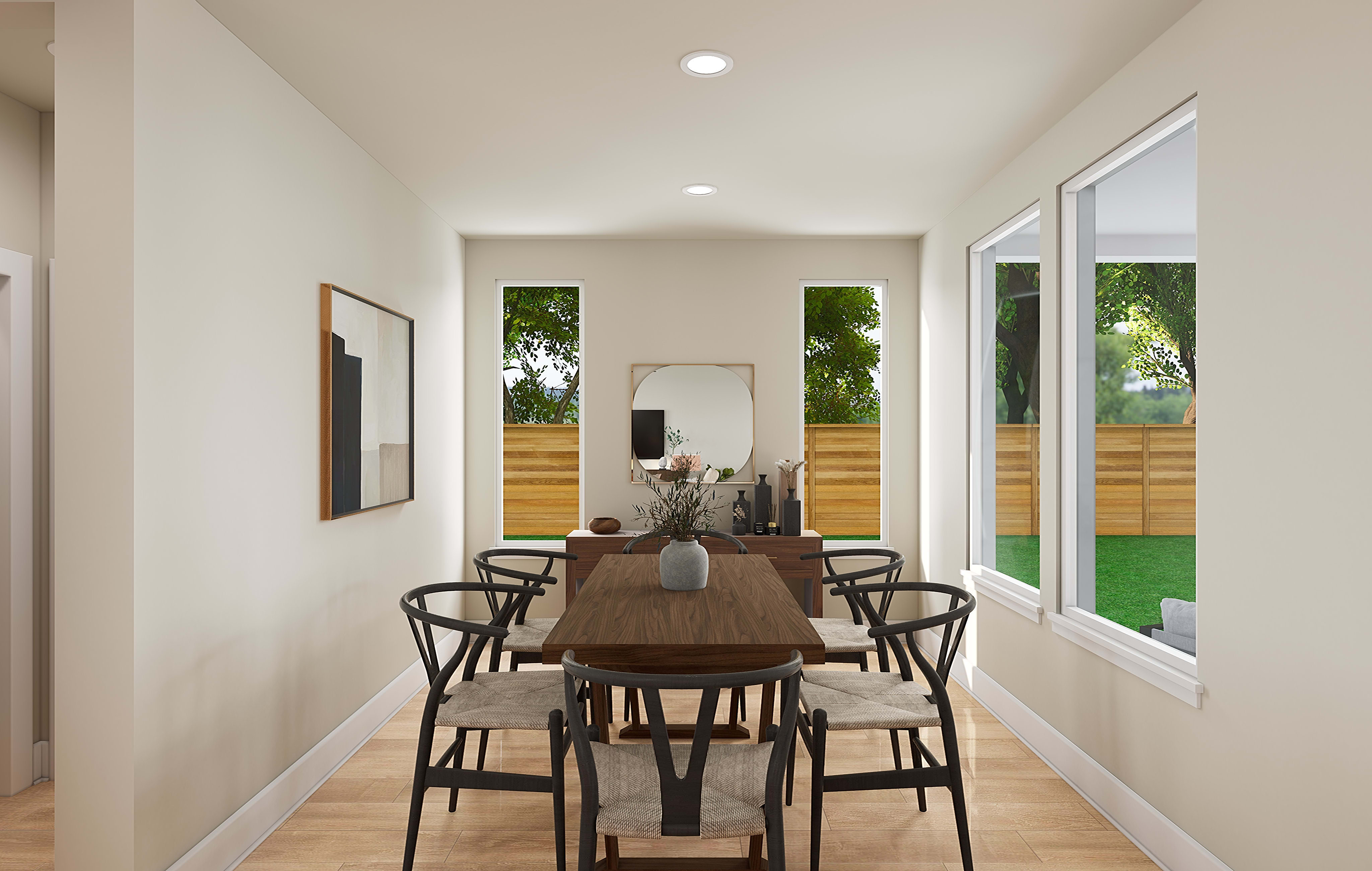 A modern and minimalist dining room with a wooden table and chairs, surrounded by large windows that provide a view of the lush greenery outside.