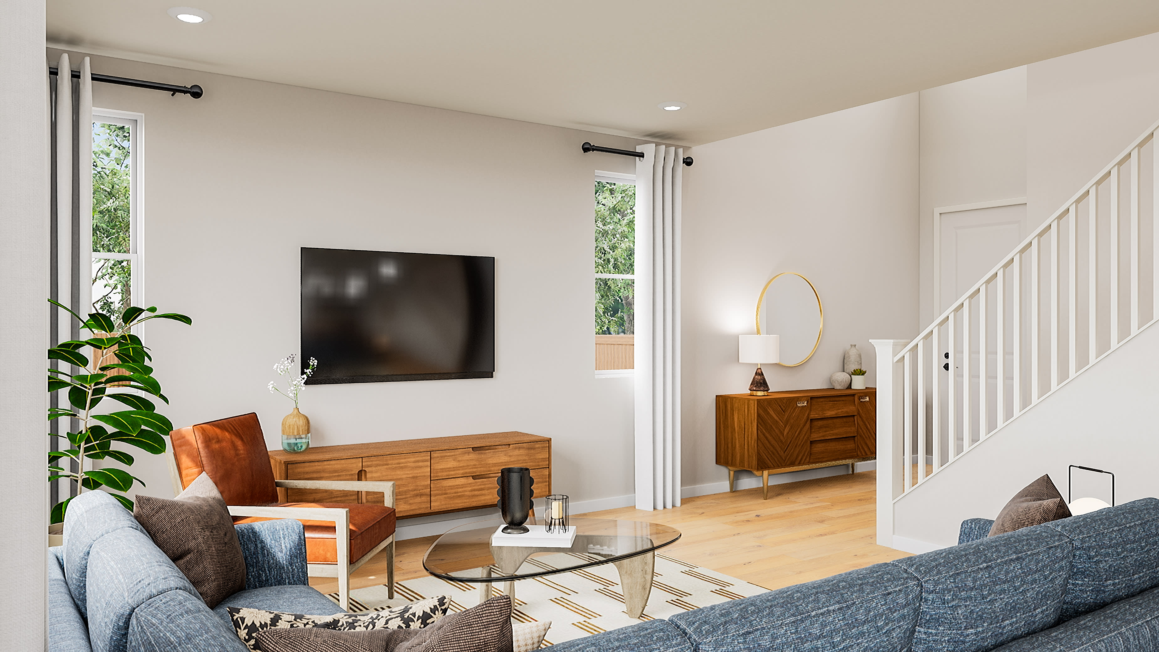 A modern living room features a blue sectional sofa in the foreground, with a wooden media console, a television, and a glass coffee table in the midground, while a staircase and a console table with a mirror are visible in the background.