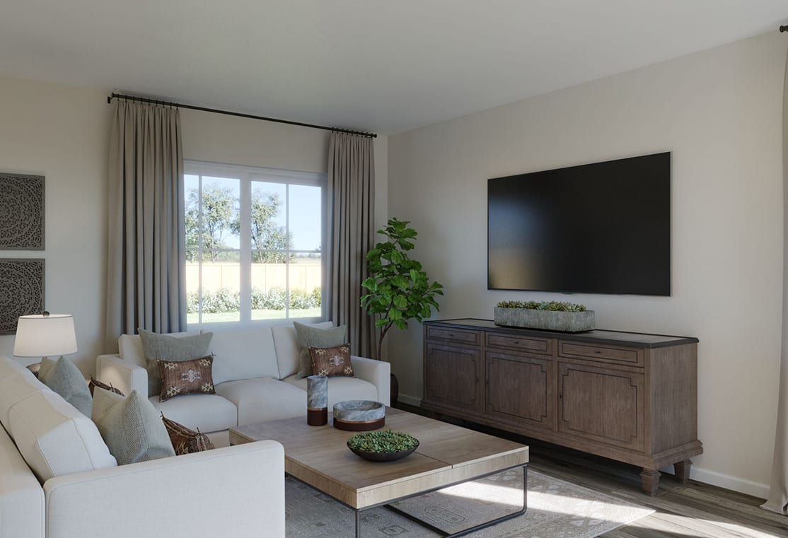 A cozy living room with a large television mounted on the wall, a wooden cabinet below, and a comfortable seating area with a coffee table and potted plant in the foreground.