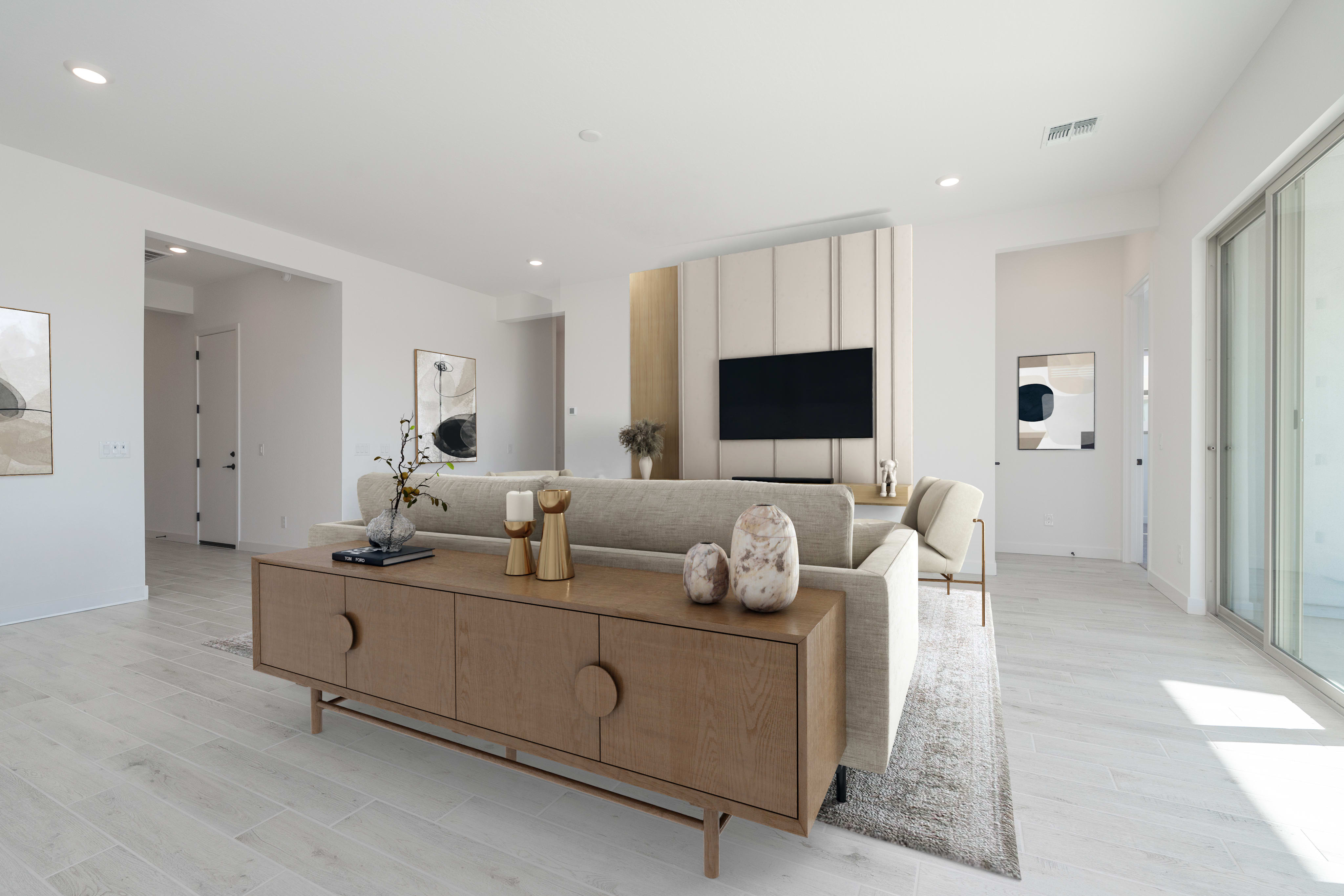 A modern living room with a wooden credenza in the foreground and a television mounted on a decorative wall in the background.