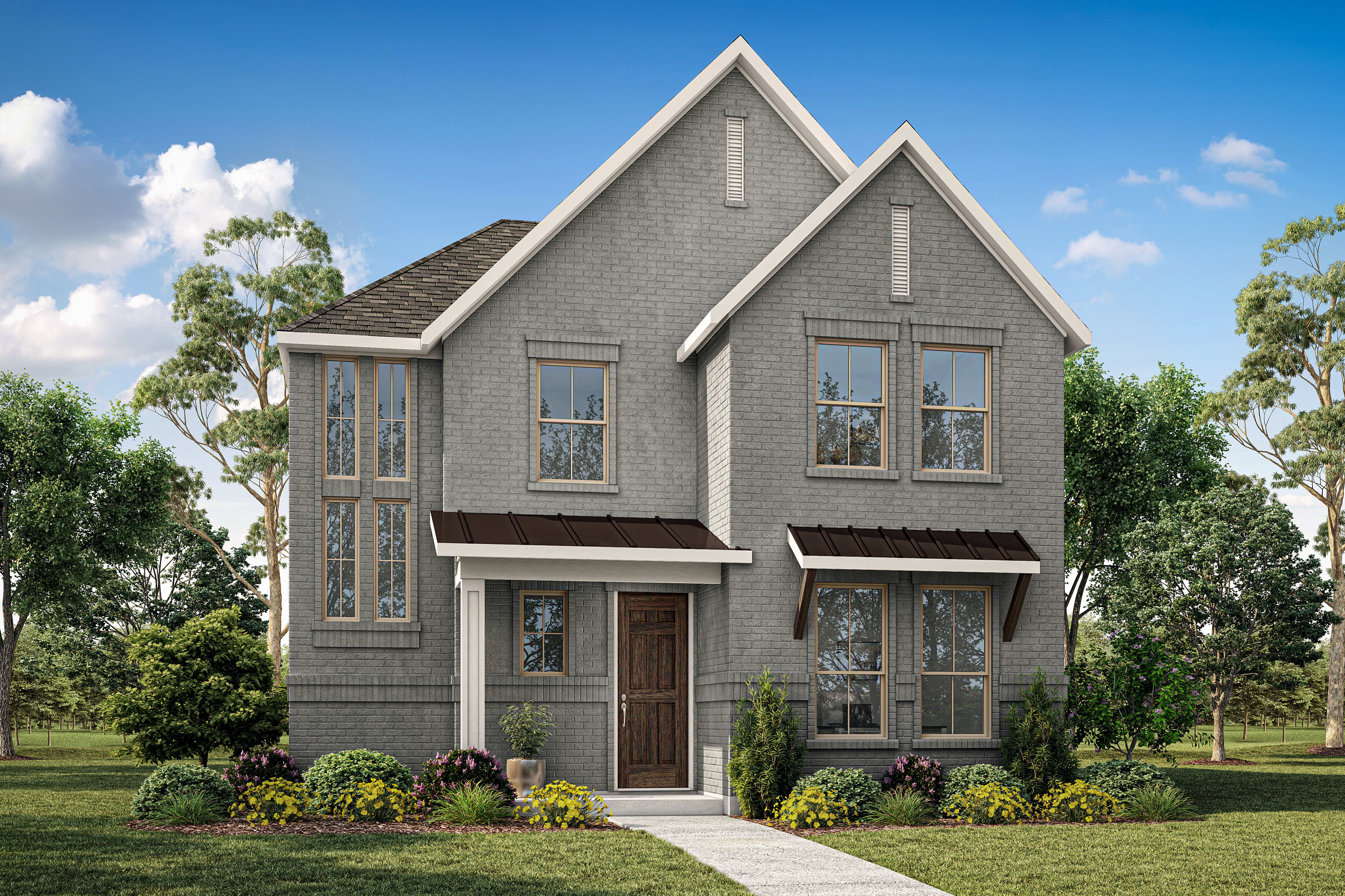 A modern gray brick house with a well-manicured lawn and lush trees under a bright blue sky.