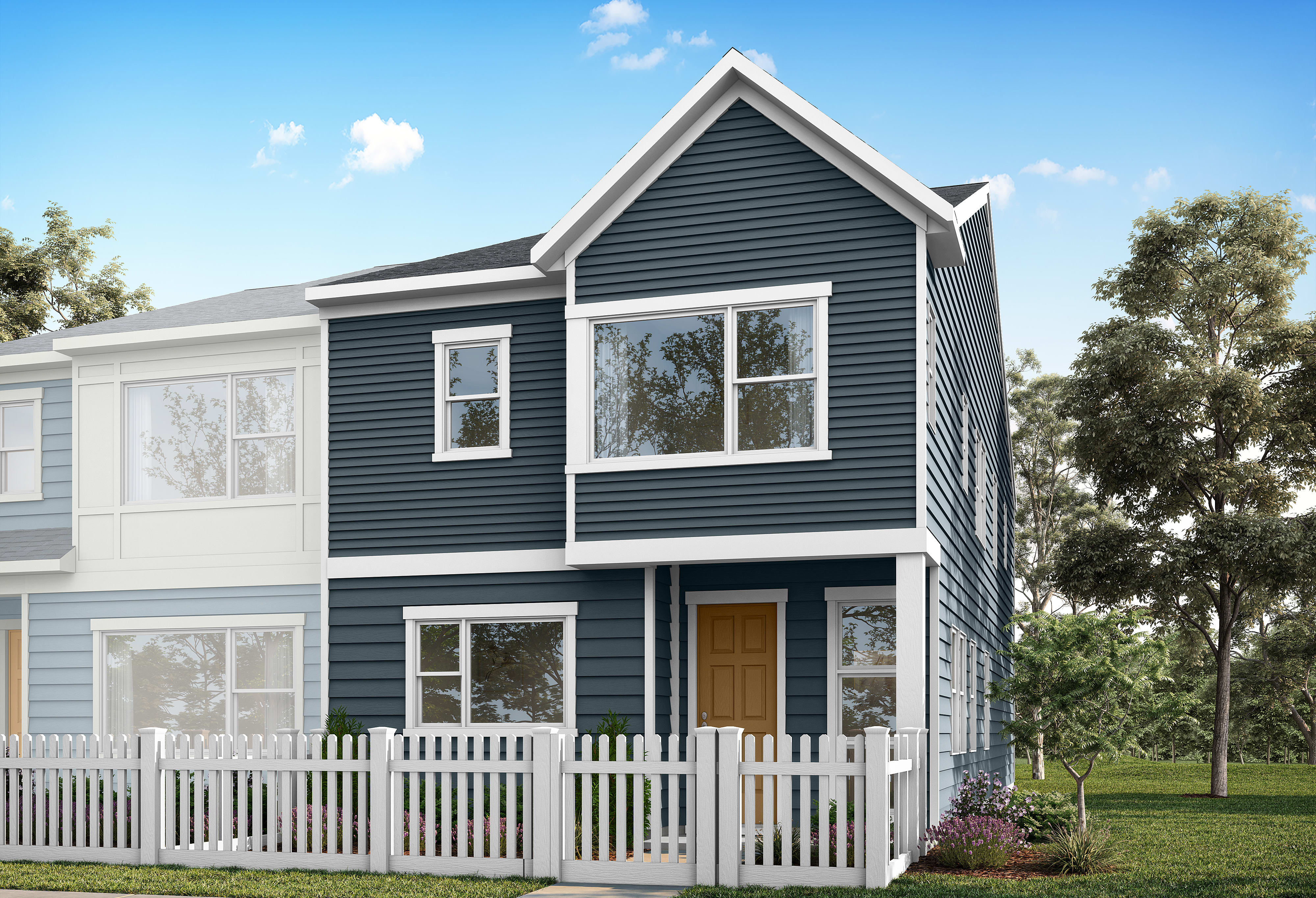 A dark blue townhouse with a white picket fence in the foreground stands against a backdrop of trees and a blue sky.