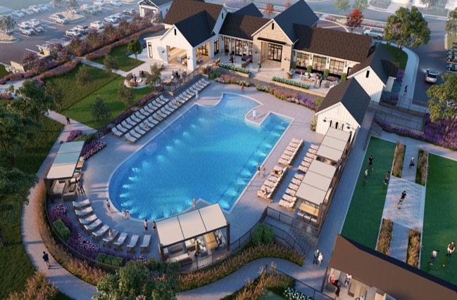 A luxurious resort with a large outdoor pool surrounded by buildings, lounge chairs, and lush greenery, set against a backdrop of a scenic landscape.