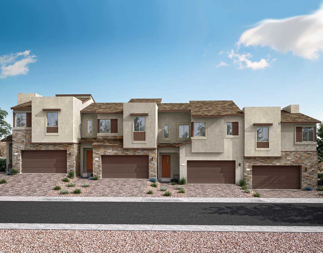 A row of modern, multi-story townhouses with stone and stucco exteriors, set against a clear blue sky with scattered clouds, and a paved driveway leading up to the garages in the foreground.
