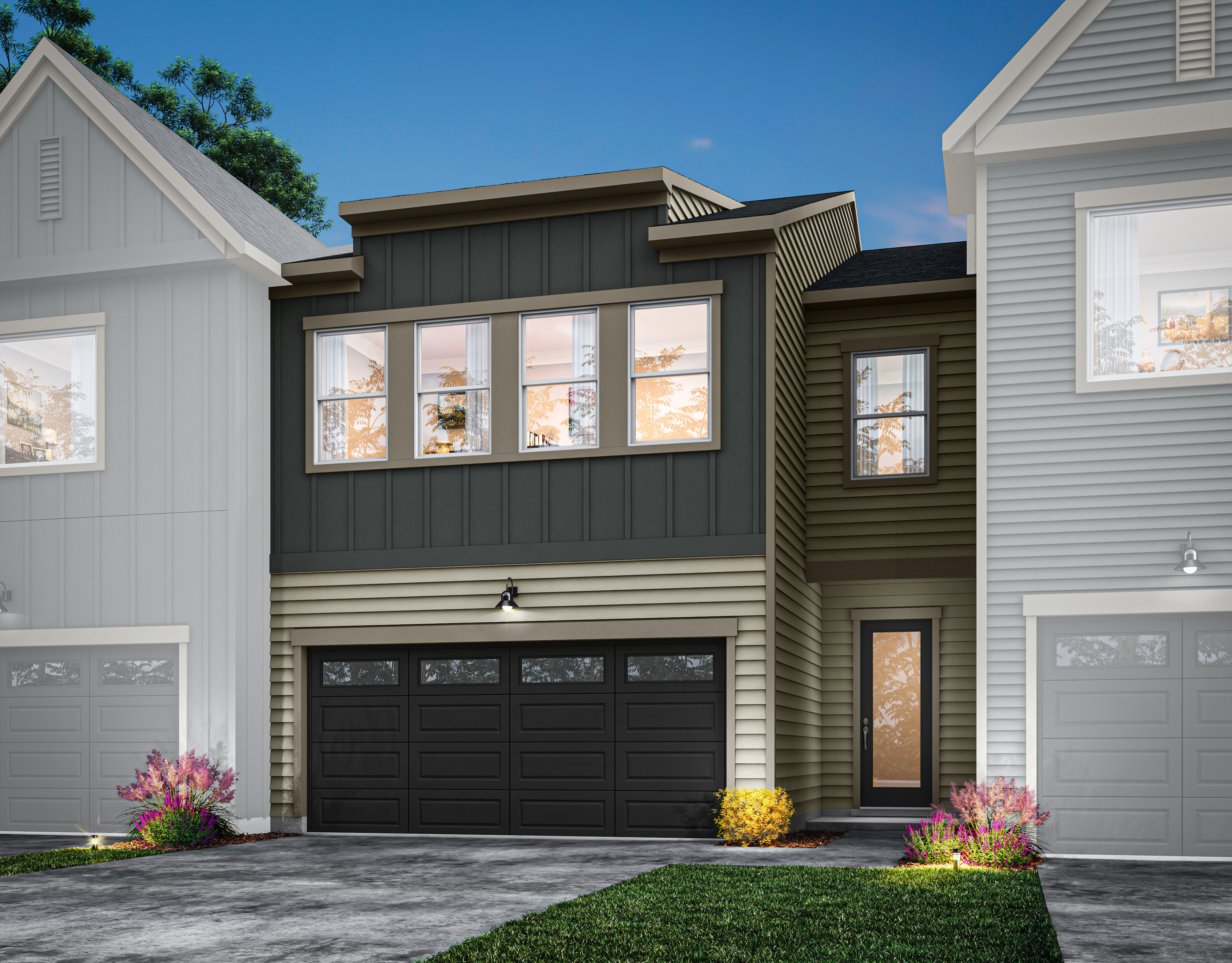 A modern two-story townhouse with a black garage door, large windows, and a landscaped front yard with colorful flowers.