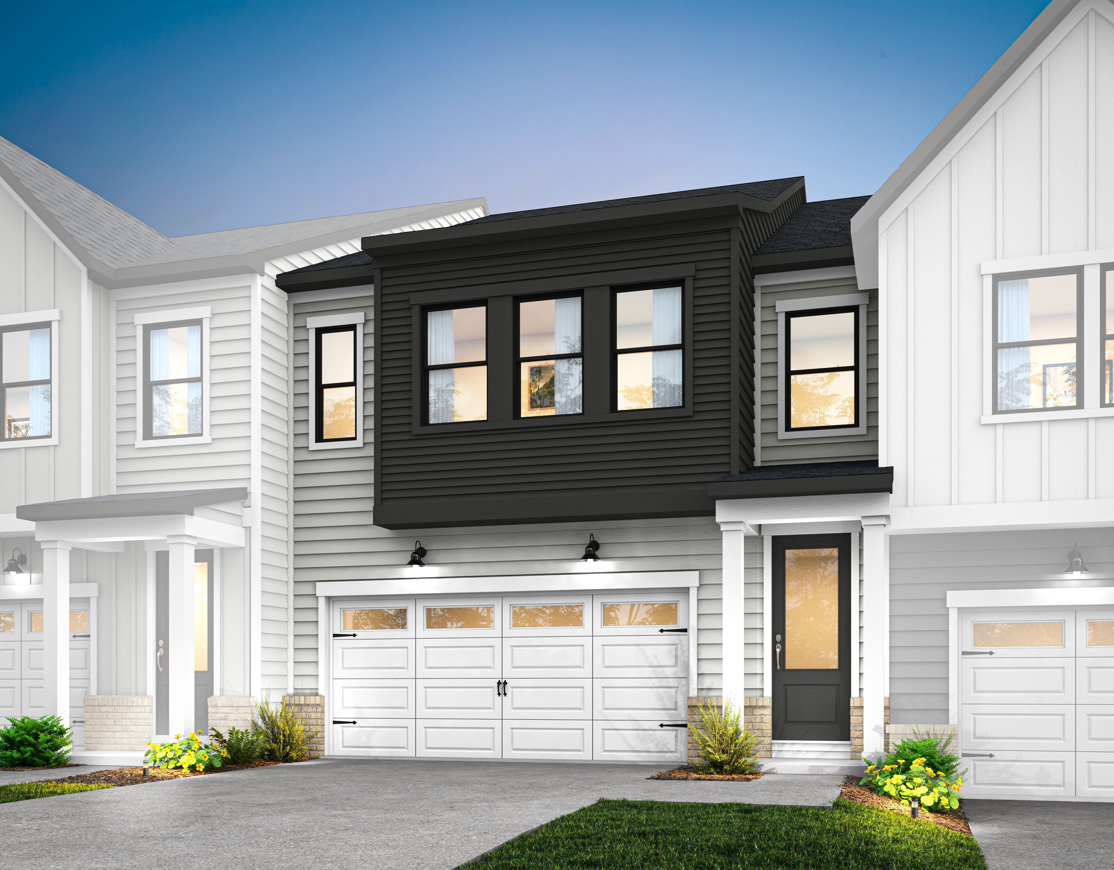 A modern townhouse with a white exterior, black trim, and a two-car garage stands in a well-manicured yard with lush greenery in the foreground.