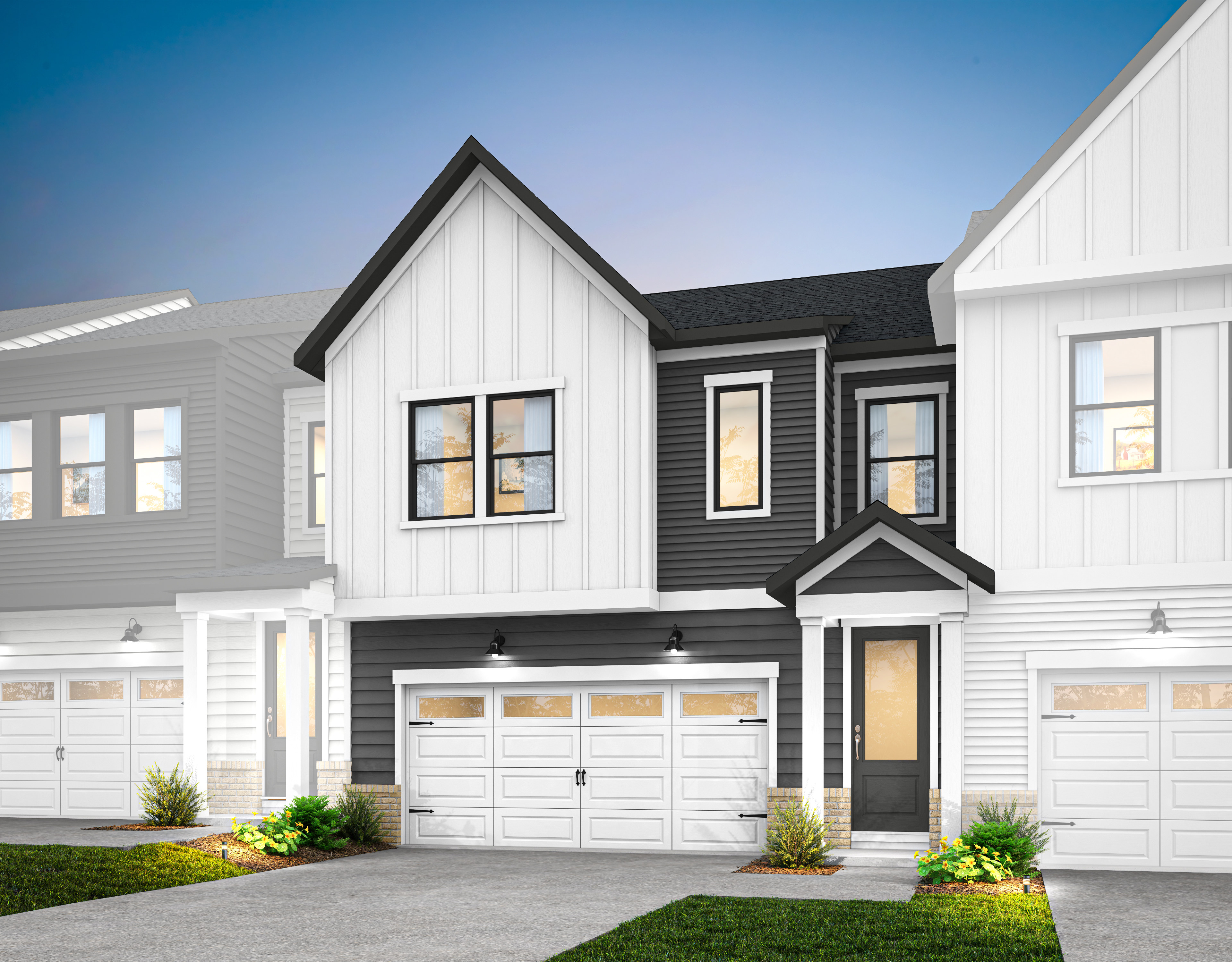 A modern two-story townhouse with a white exterior, black trim, and a garage door in the foreground, set against a clear blue sky in the background.