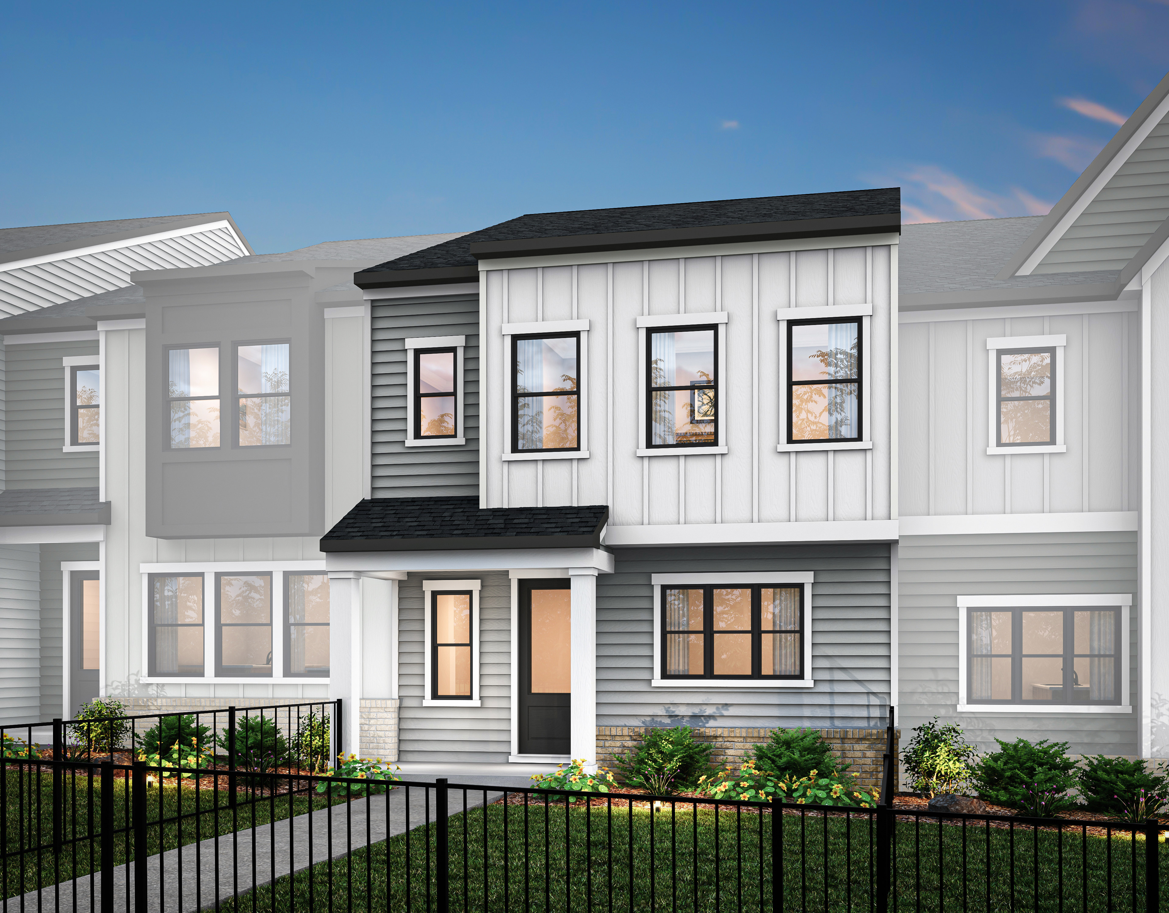 A modern, two-story townhouse with a gray exterior, white trim, and a black roof, surrounded by a metal fence and landscaping in the foreground.