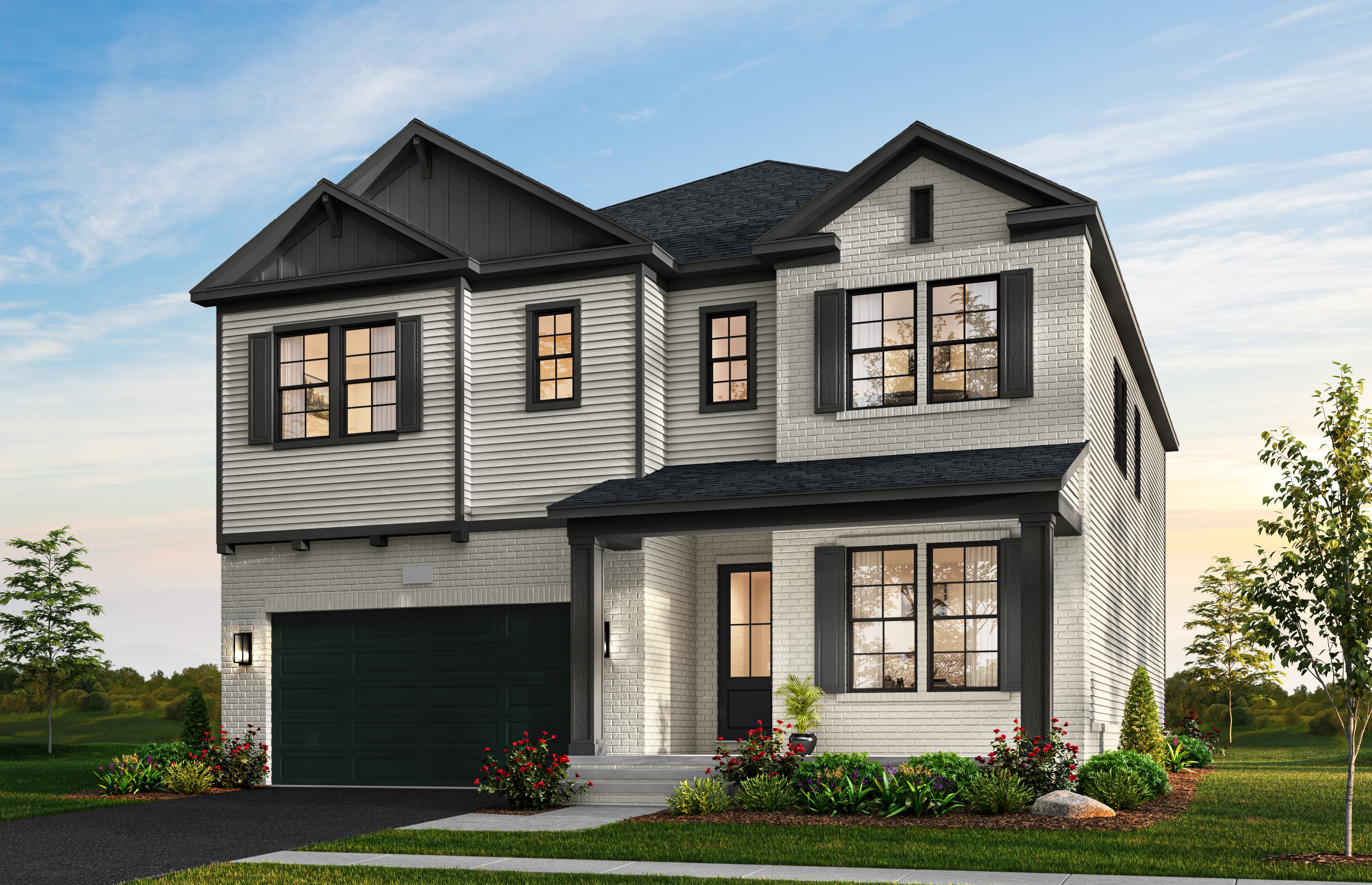 A two-story gray and white house with a garage, surrounded by a well-landscaped yard with trees and flowers in the foreground, set against a backdrop of a clear blue sky.