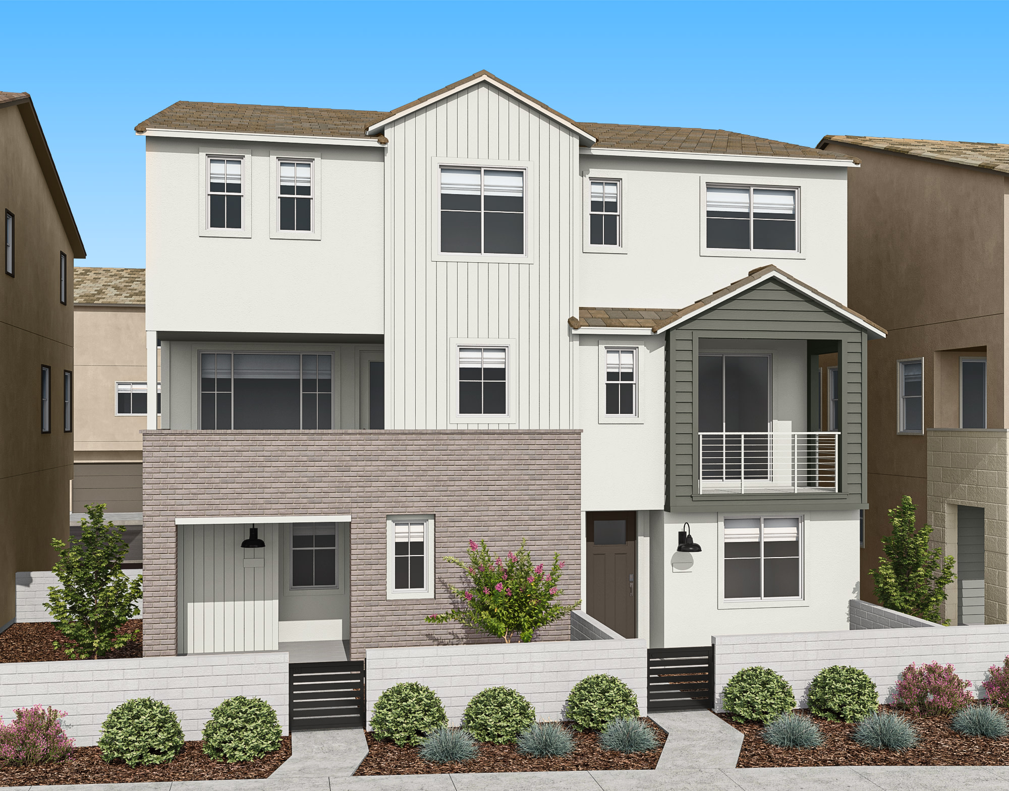 A modern, multi-story townhouse with a well-landscaped front yard, set against a clear blue sky.