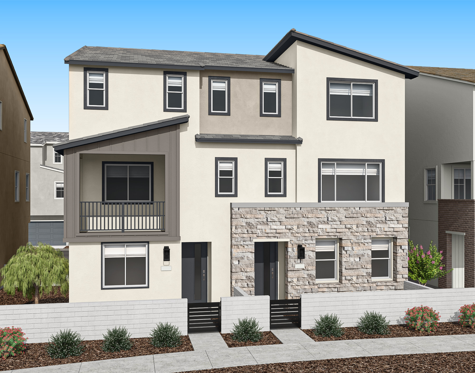 A modern, two-story residential building with a stone facade, surrounded by landscaped greenery and a clear blue sky in the background.