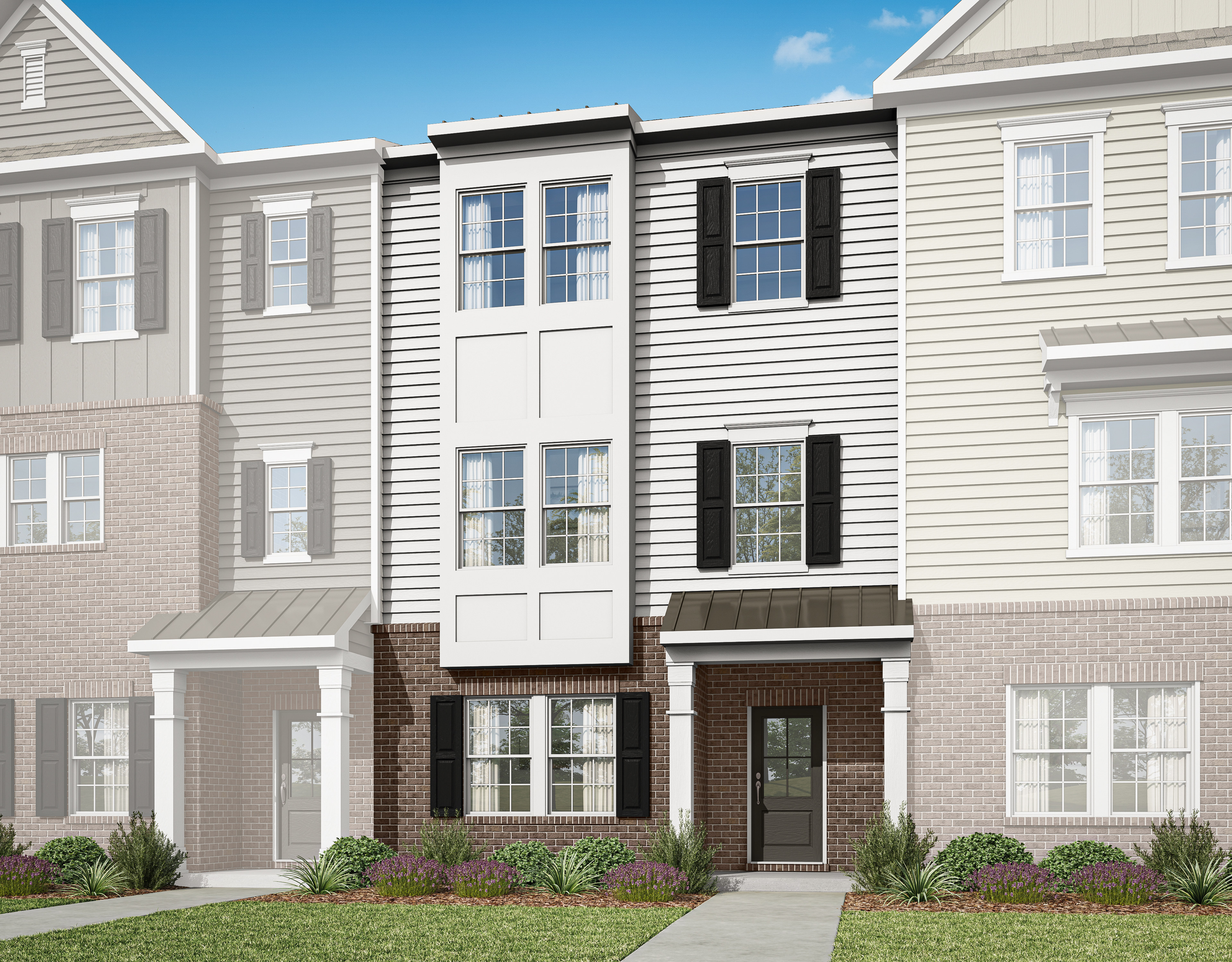 A multi-story townhouse with a brick and siding exterior, surrounded by landscaping, set against a clear blue sky.