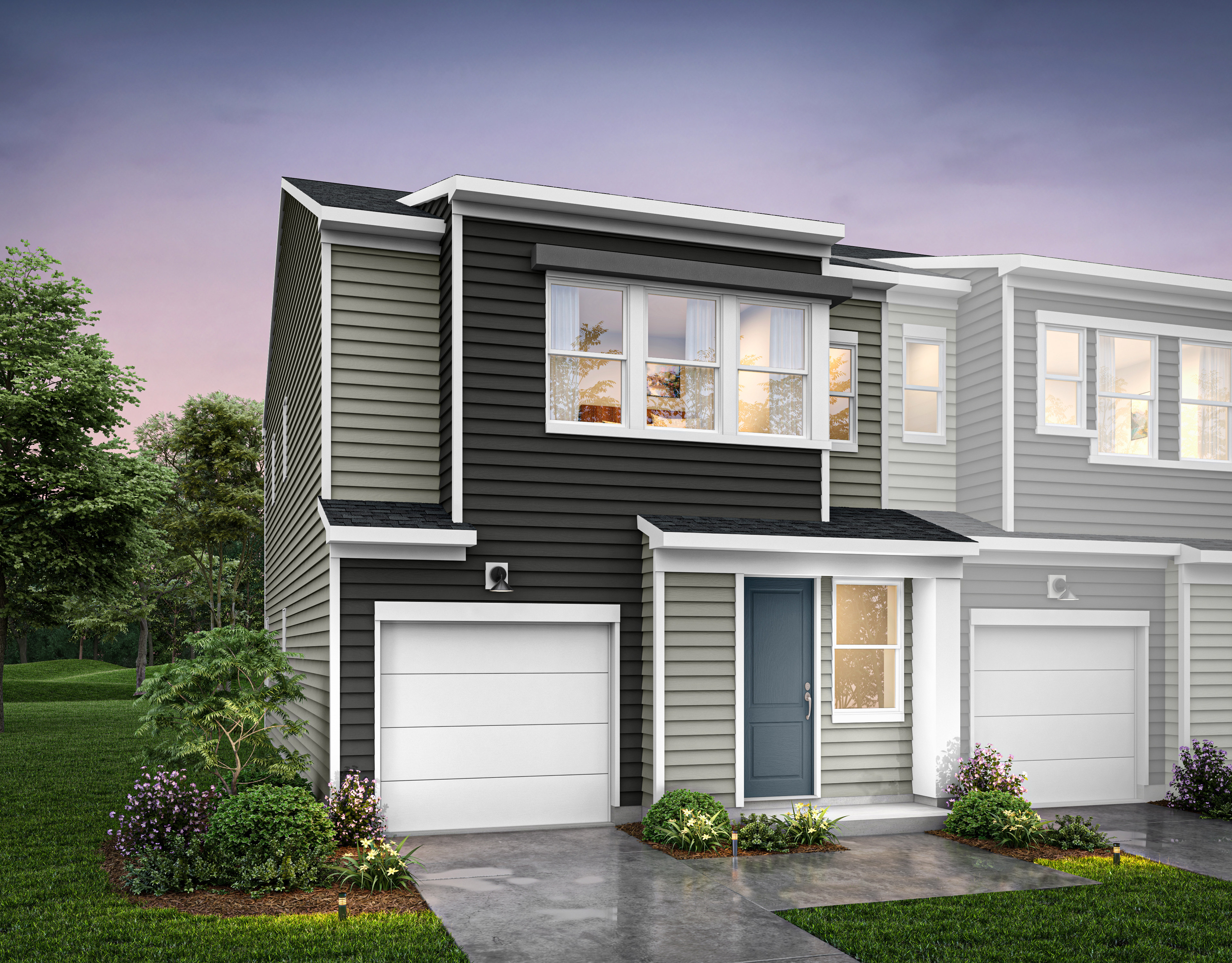 A modern two-story townhouse with a gray exterior, white trim, and a landscaped front yard featuring flowers and shrubs.