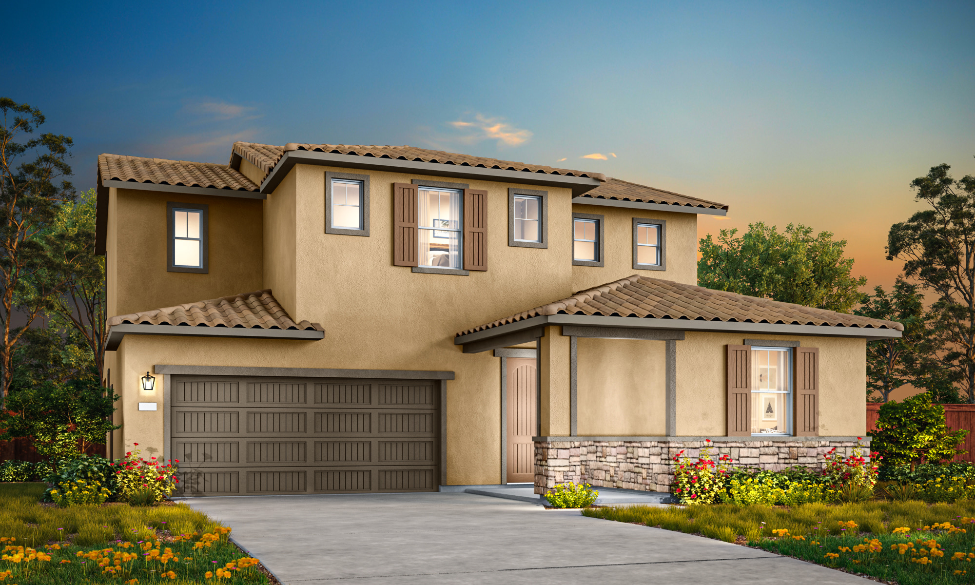 A two-story Mediterranean-style house with a tiled roof, a garage door, and a landscaped yard with colorful flowers in the foreground, set against a backdrop of a blue sky with clouds.