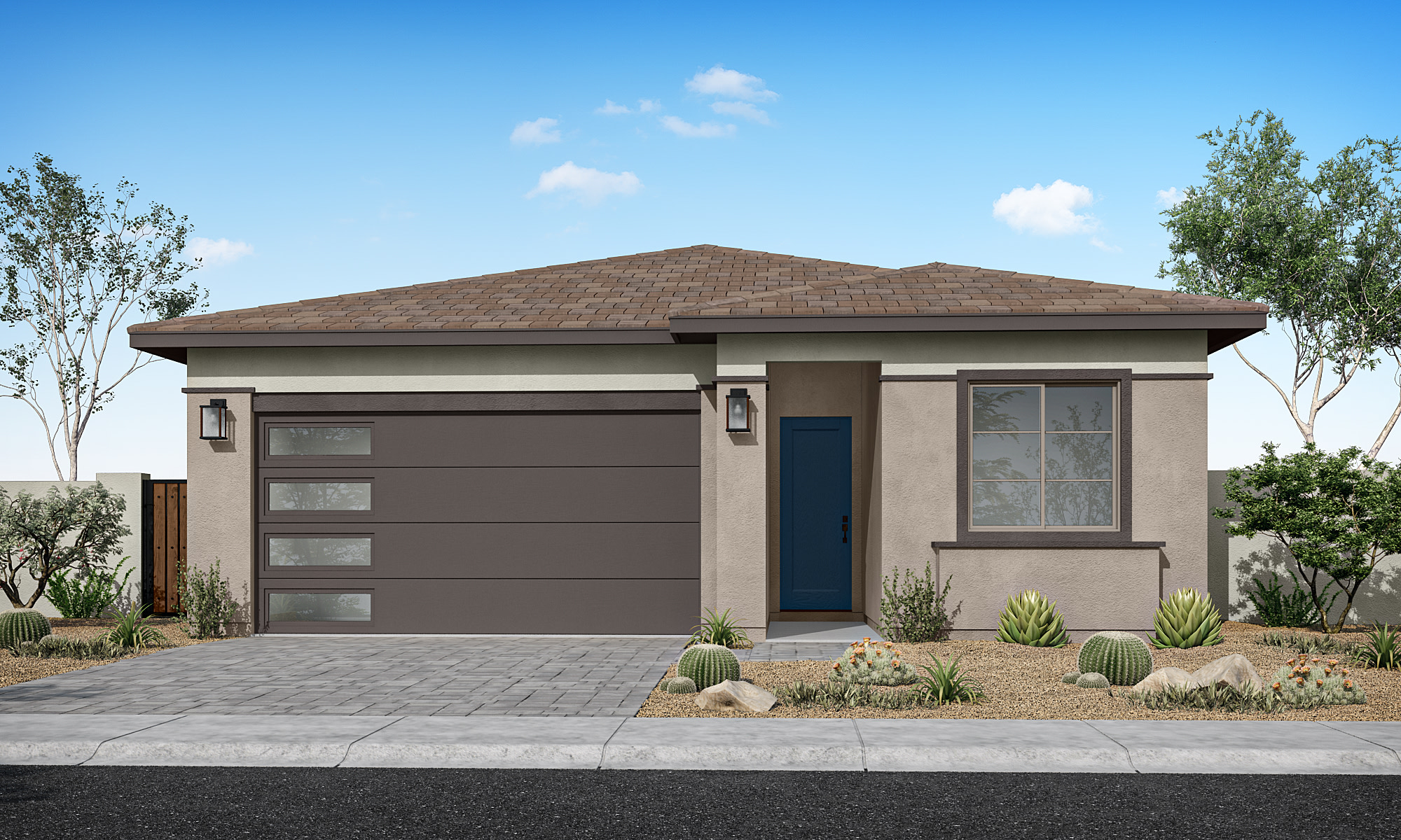 A modern, single-story house with a brown tiled roof, gray exterior walls, and a paved driveway leading to the front entrance. The house is surrounded by desert landscaping, including cacti and other drought-tolerant plants, set against a clear blue sky with scattered clouds.