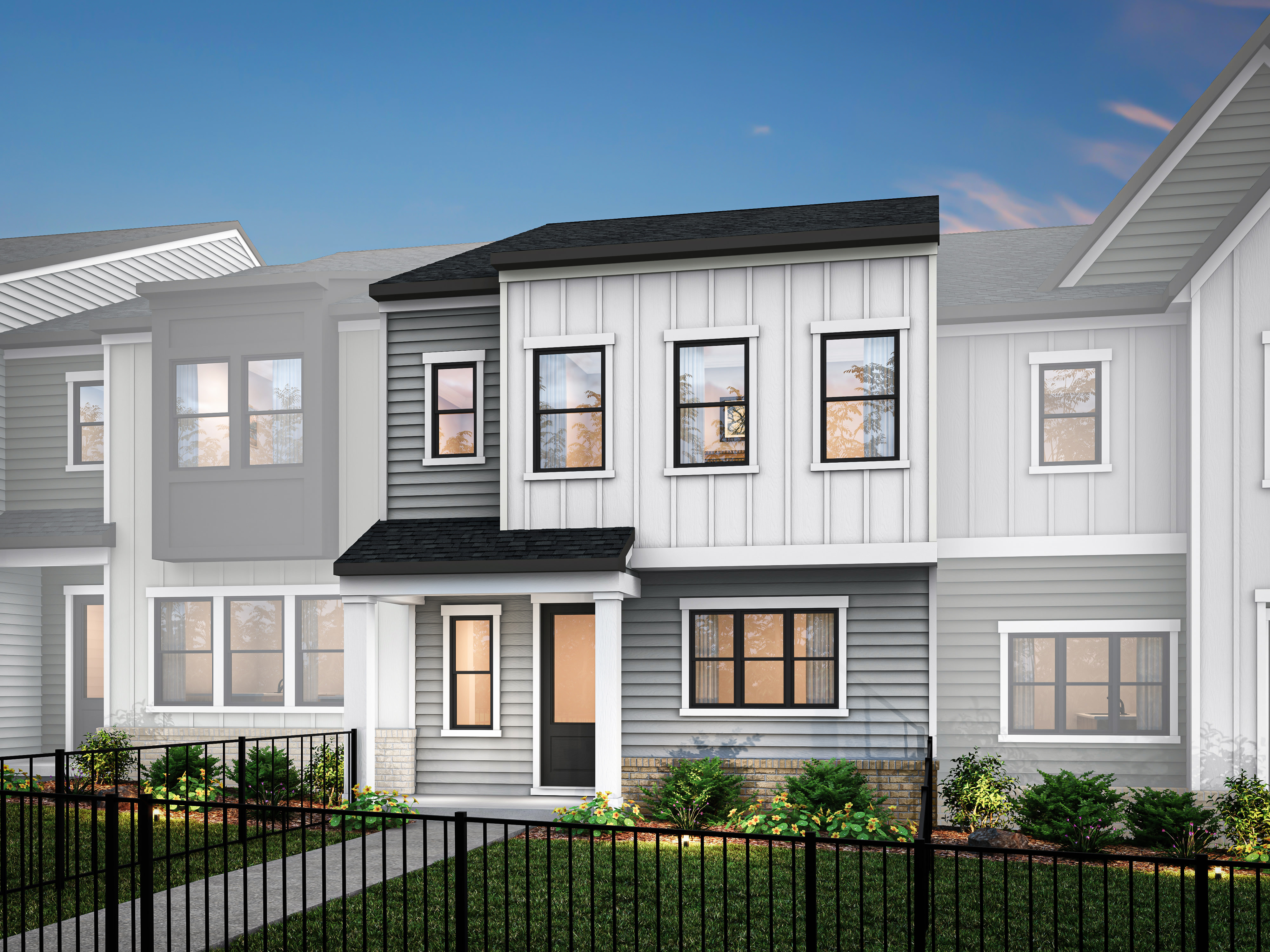 A modern, two-story townhouse with a gray exterior, white trim, and a black roof, surrounded by a metal fence and landscaping in the foreground.