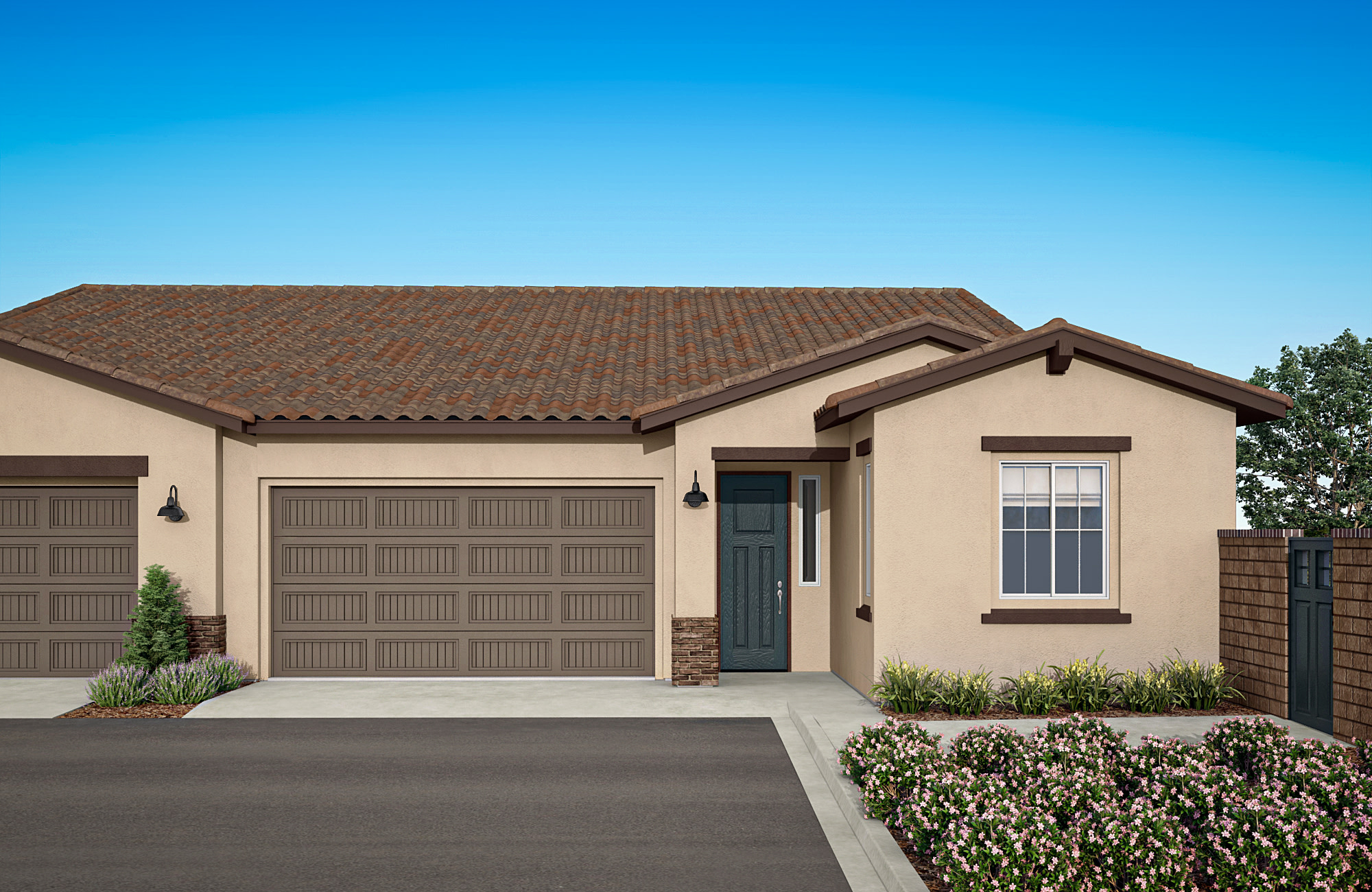 A single-story house with a brown tile roof, beige exterior walls, and a two-car garage stands in a well-landscaped yard with shrubs and trees in the foreground against a clear blue sky.