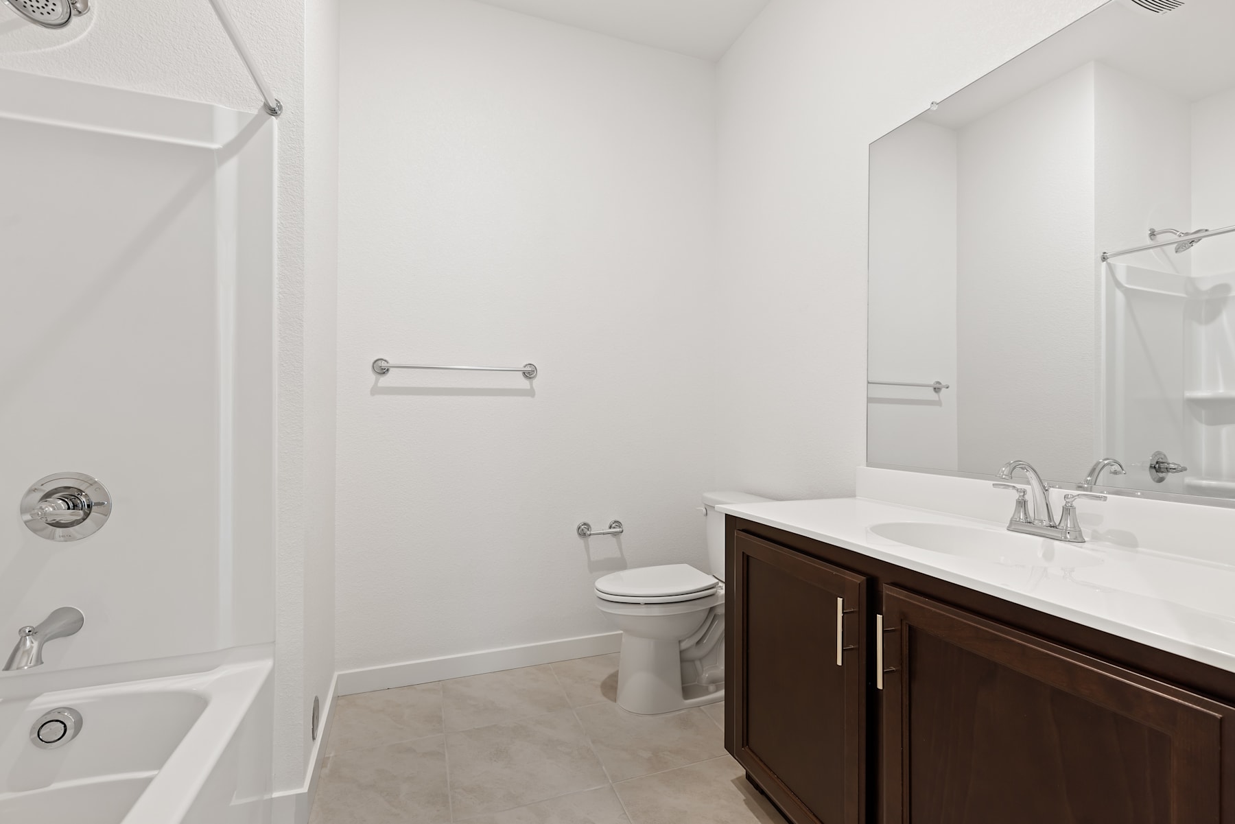 A modern and clean bathroom with a vanity cabinet, toilet, and shower visible in the image.