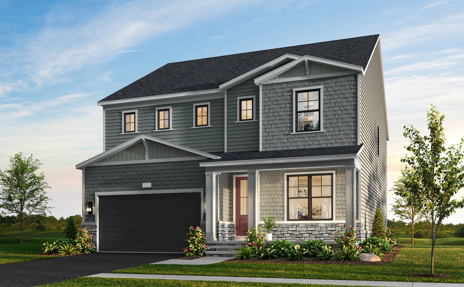 A two-story residential house with a garage, surrounded by a well-manicured lawn and trees in the background, under a clear blue sky.
