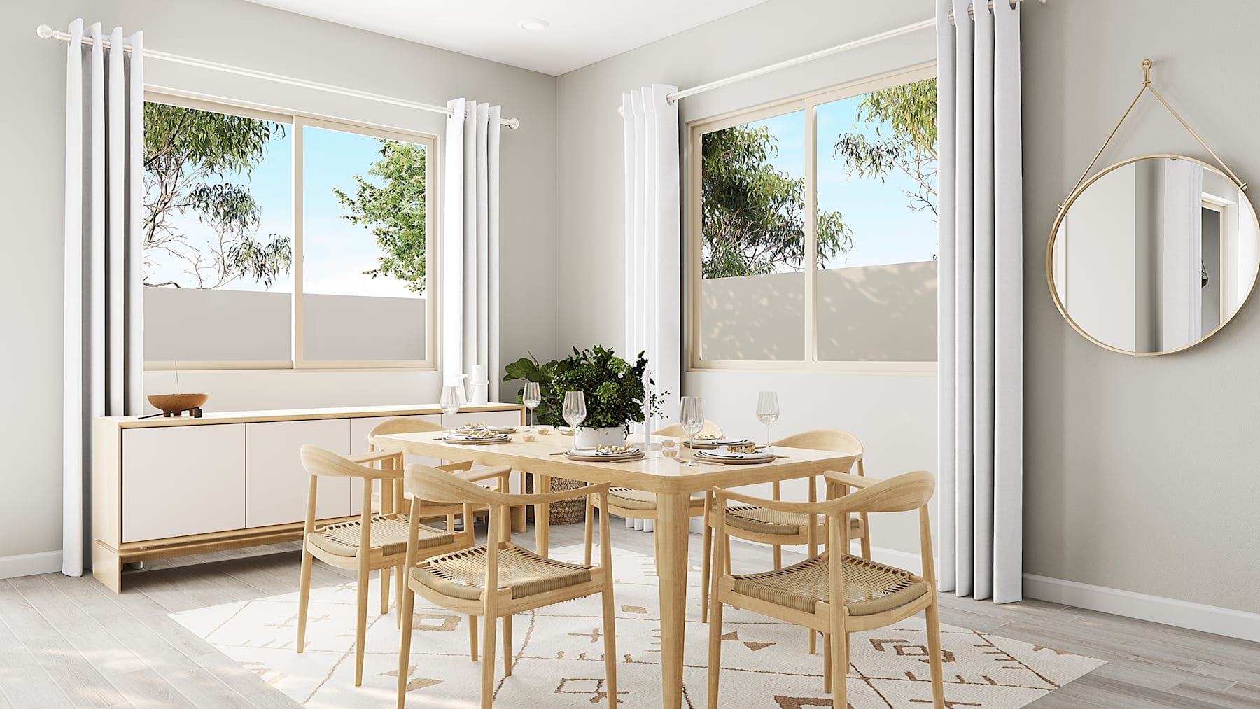 A bright and airy dining area with a wooden table and chairs, surrounded by large windows overlooking lush greenery outside.