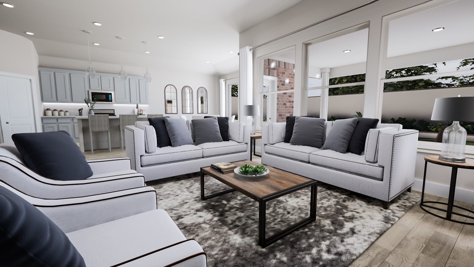 A modern and spacious living room with gray sofas, a wooden coffee table, and a kitchen visible in the background.