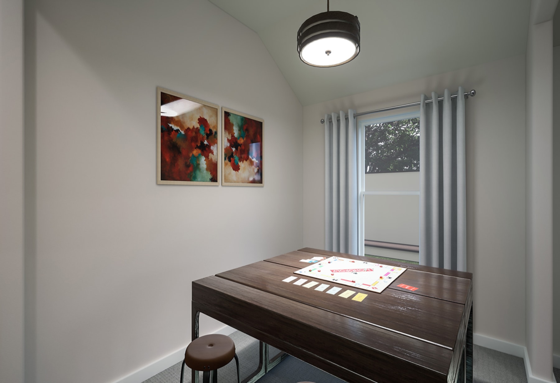 A modern and minimalist interior space with a dark wooden table, abstract artwork on the walls, and a circular light fixture hanging from the ceiling.