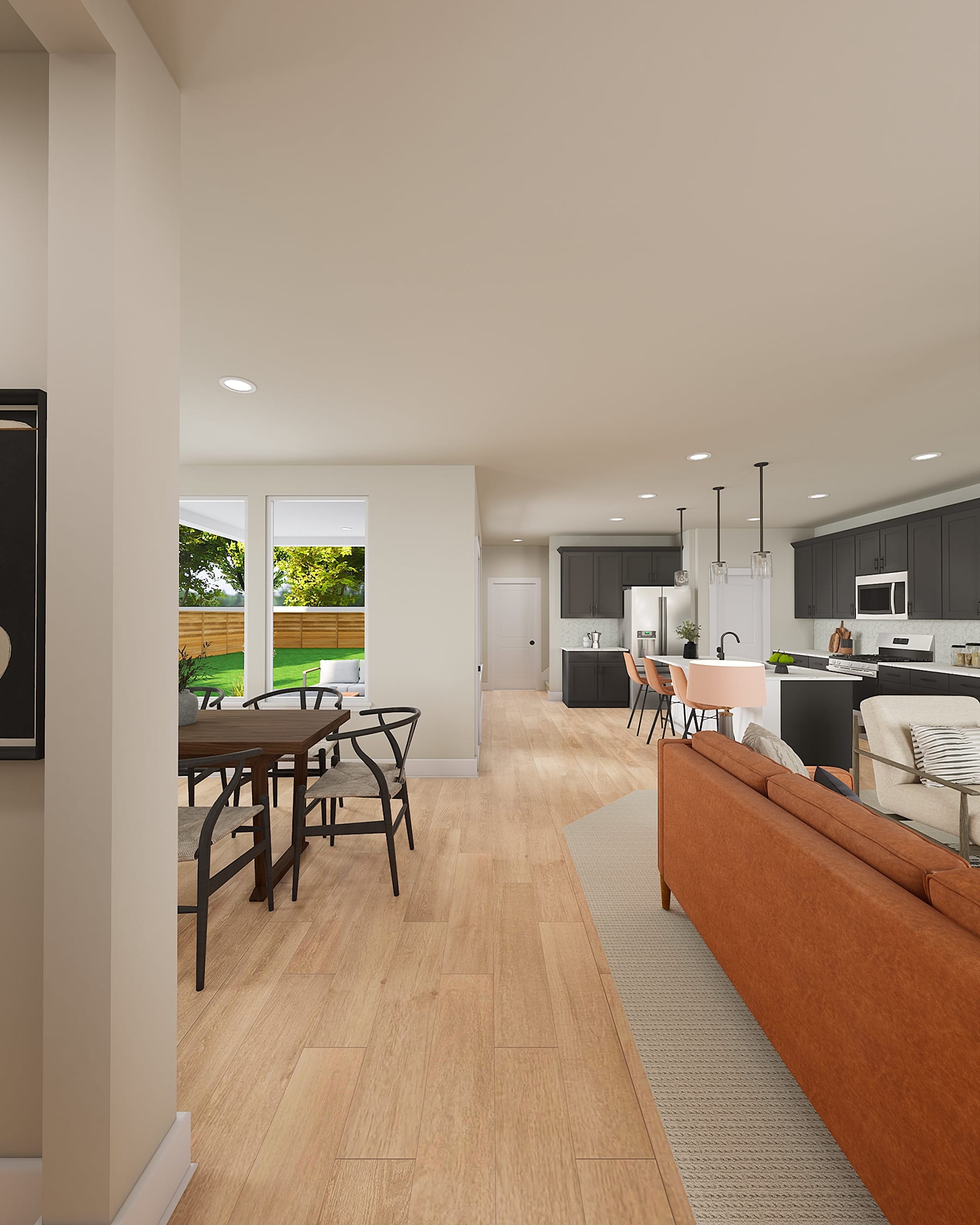 A modern and open-concept living space with a dining area, kitchen, and living room visible, featuring hardwood floors, large windows, and a cozy atmosphere.