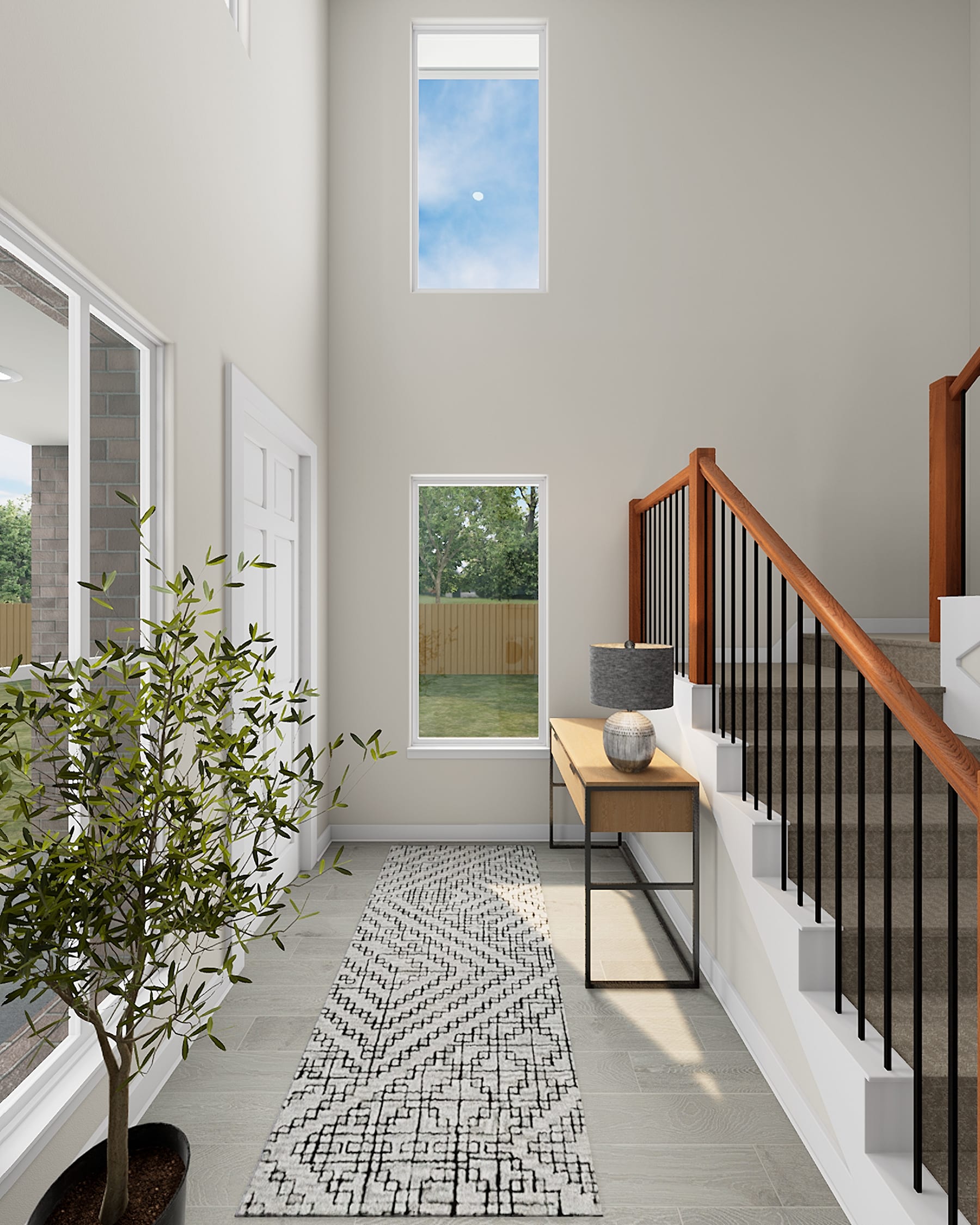 A spacious and modern entryway with a potted plant, a wooden bench, and a patterned rug leading to a staircase with a metal railing, all set against a backdrop of large windows and a view of the outdoors.