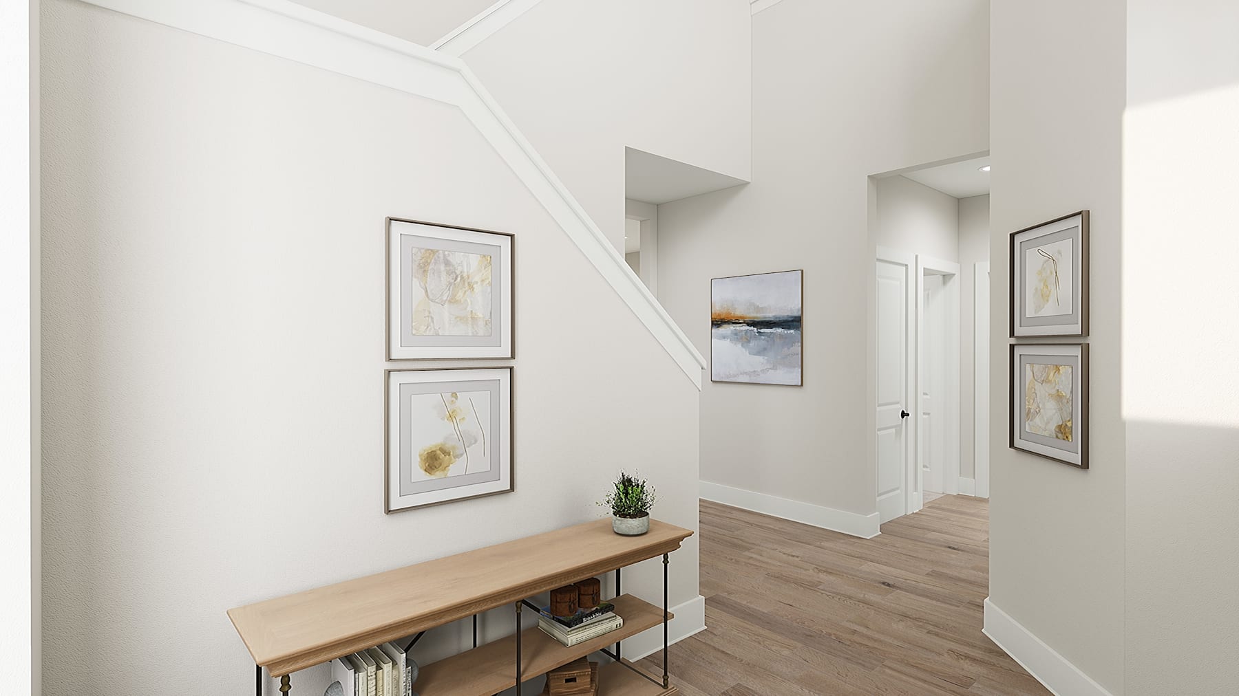 A bright and airy hallway with framed artwork on the walls, a wooden bench, and a potted plant, leading to a doorway in the background.
