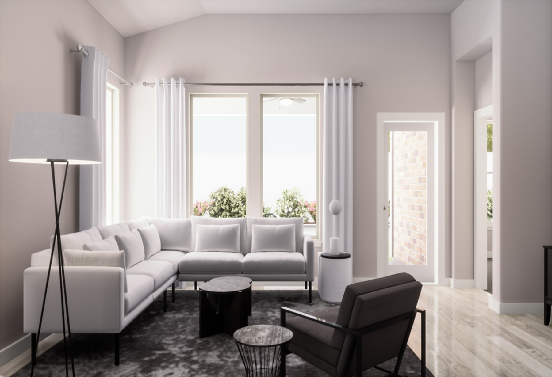 A modern and minimalist living room with a large white sectional sofa, a black coffee table, and a floor lamp, set against a backdrop of large windows overlooking a lush outdoor environment.