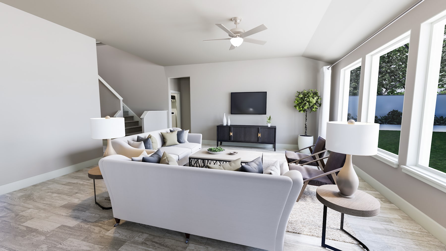 A modern and minimalist living room with a white sofa, armchairs, and a TV stand, set against a backdrop of large windows overlooking a scenic outdoor view.