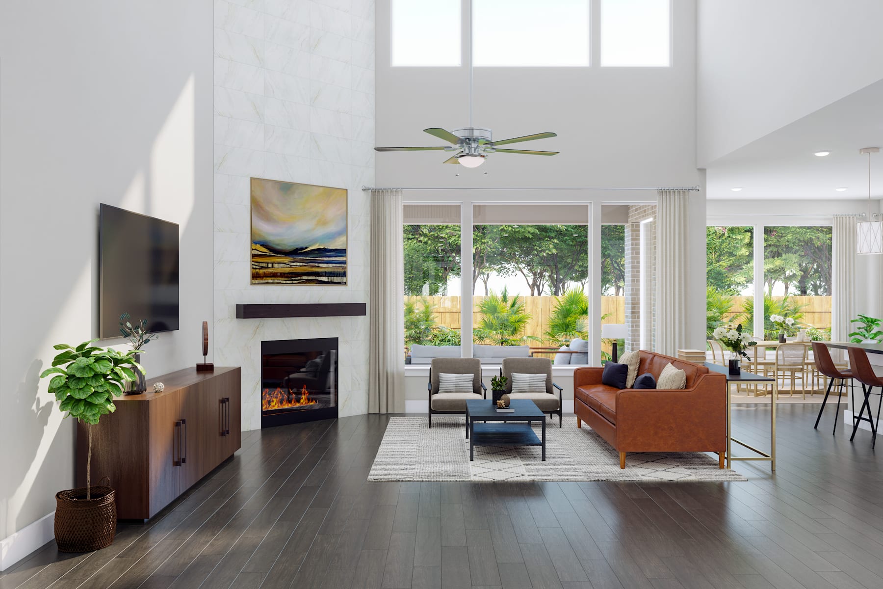 A spacious and well-lit living room with a fireplace, comfortable furniture, and large windows overlooking a lush outdoor landscape.