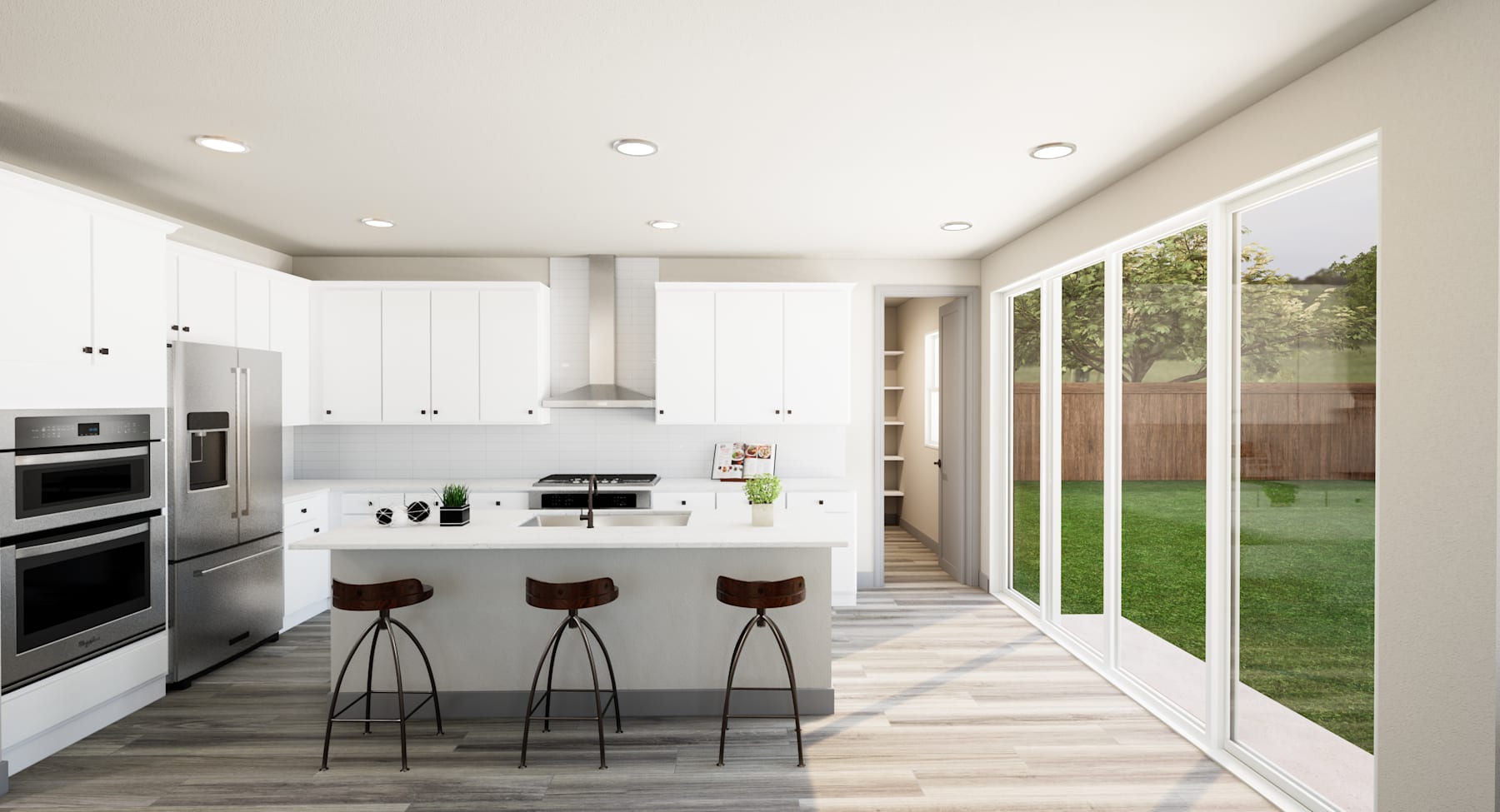 A modern, open-concept kitchen with white cabinets, stainless steel appliances, and a sliding glass door leading to a grassy backyard.