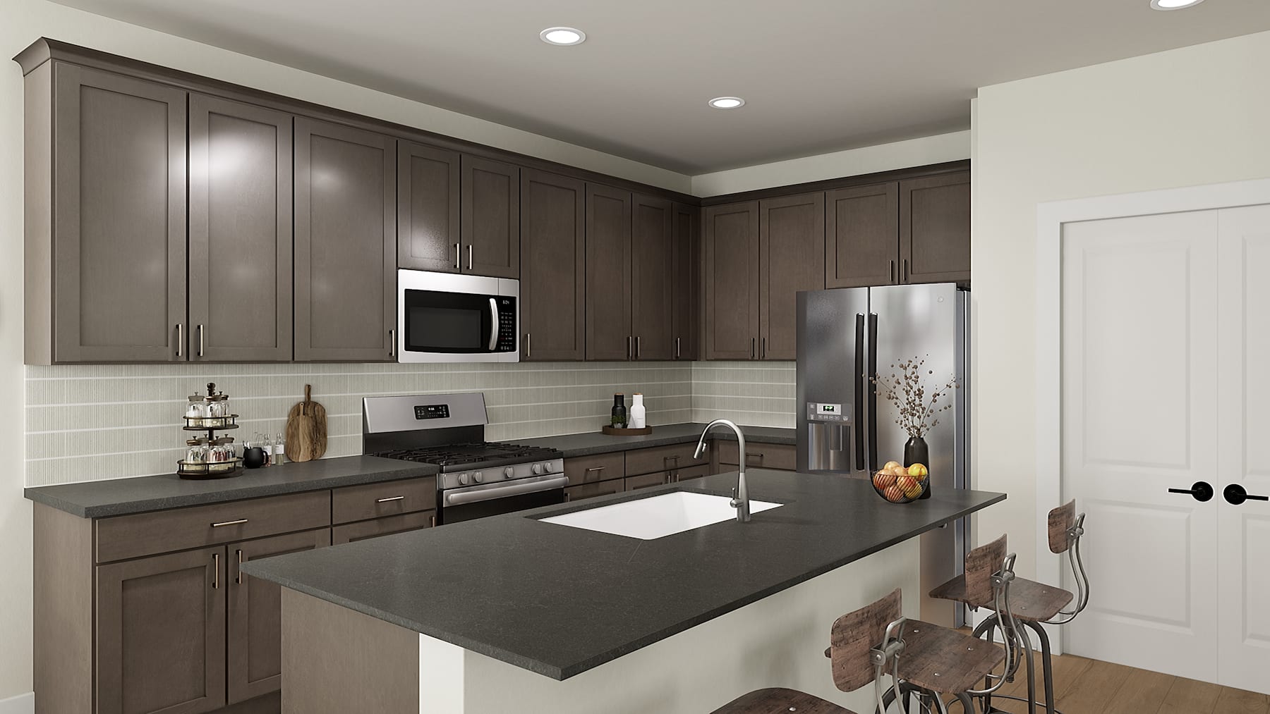 A modern, well-equipped kitchen with dark wood cabinets, stainless steel appliances, and a large central island with a black countertop.