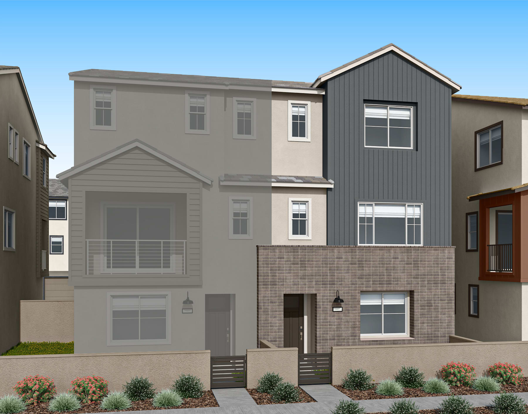 A multi-story residential building with a gray exterior, featuring a garage, balconies, and landscaped front yard, set against a clear blue sky.