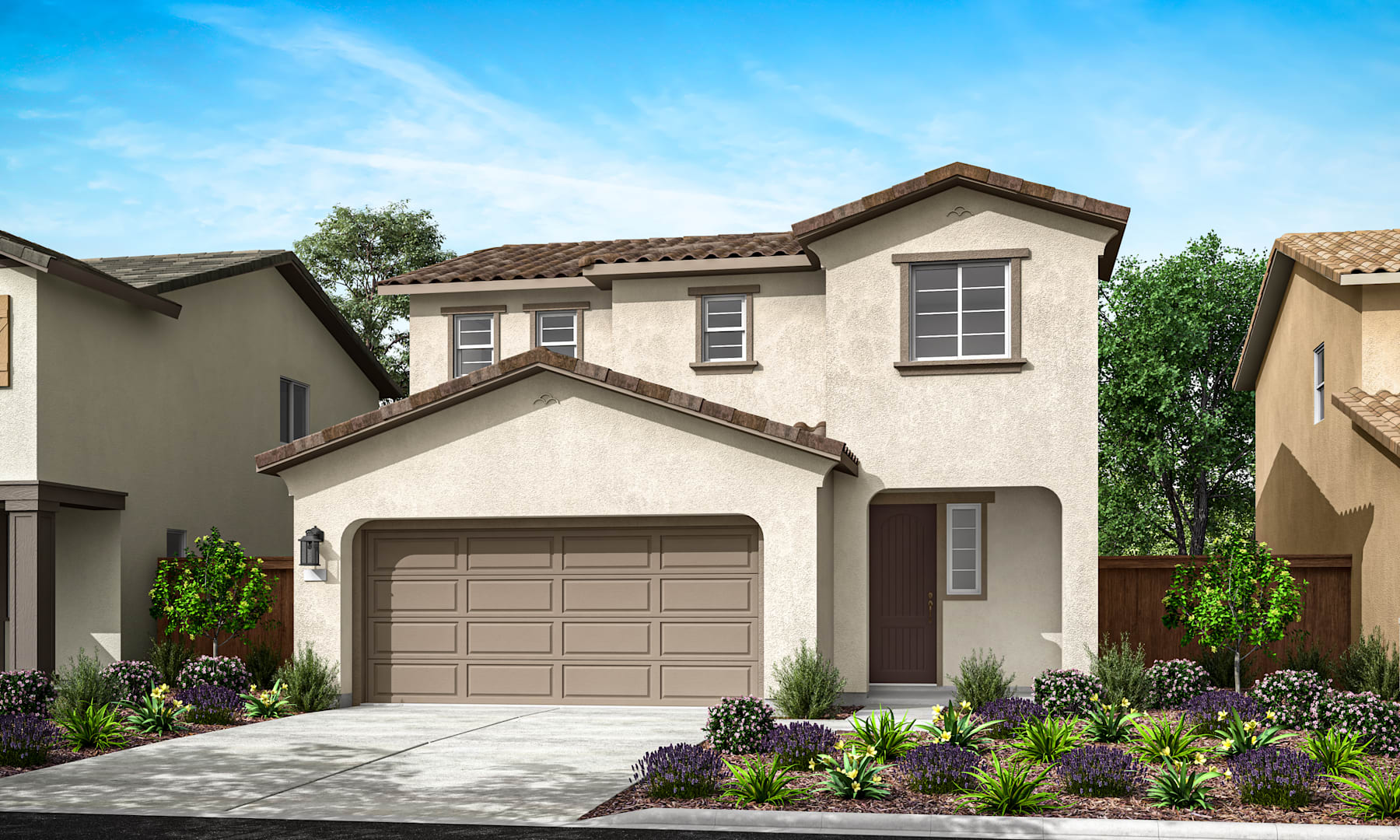 A two-story stucco house with a tiled roof, a garage door, and a well-landscaped front yard with various plants and flowers.