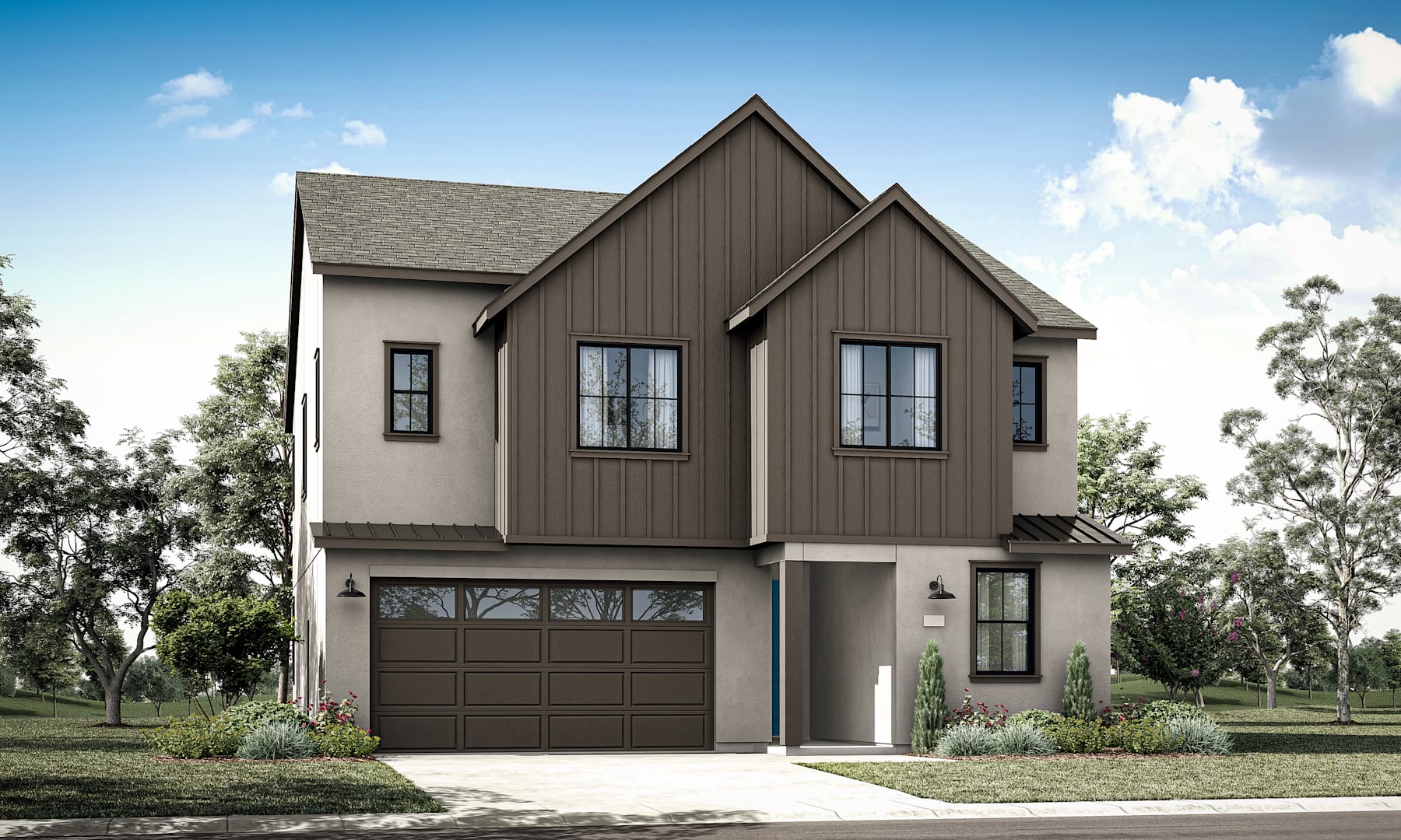 A two-story modern house with a gabled roof, dark siding, and a garage door stands in a grassy area surrounded by trees.