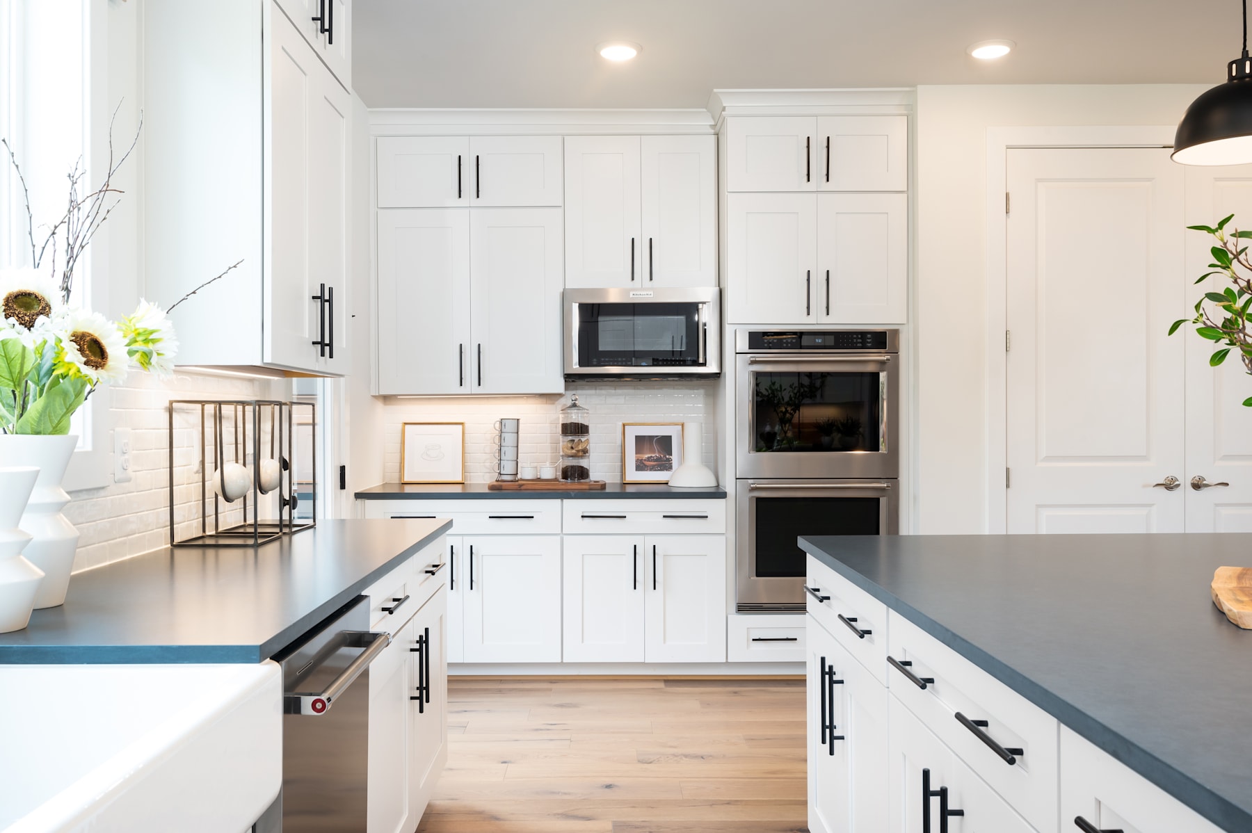 A modern, well-equipped kitchen with white cabinets, stainless steel appliances, and a sleek, minimalist design.