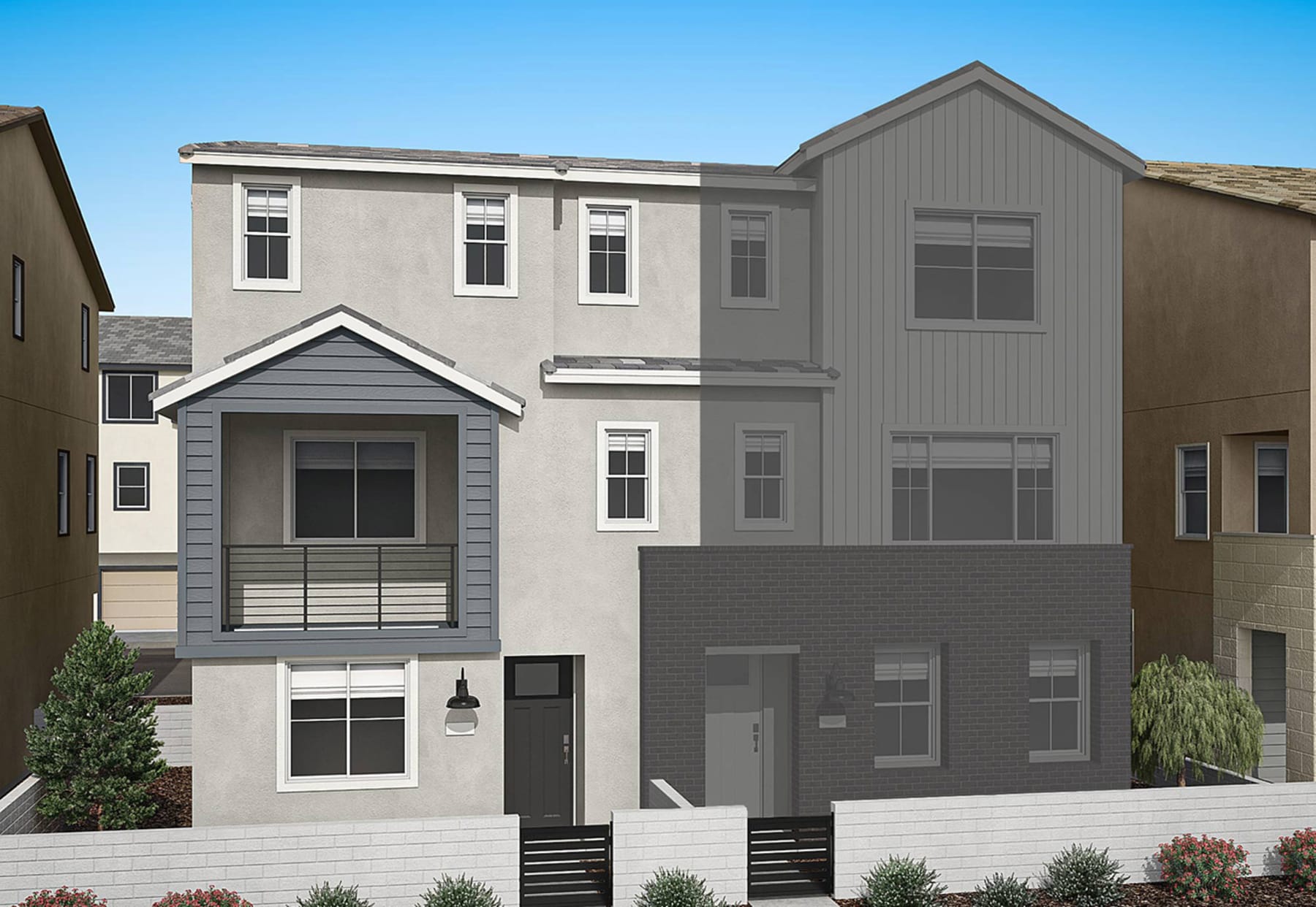 A multi-story residential building with a gray exterior, featuring a front porch and various windows, set against a clear blue sky.