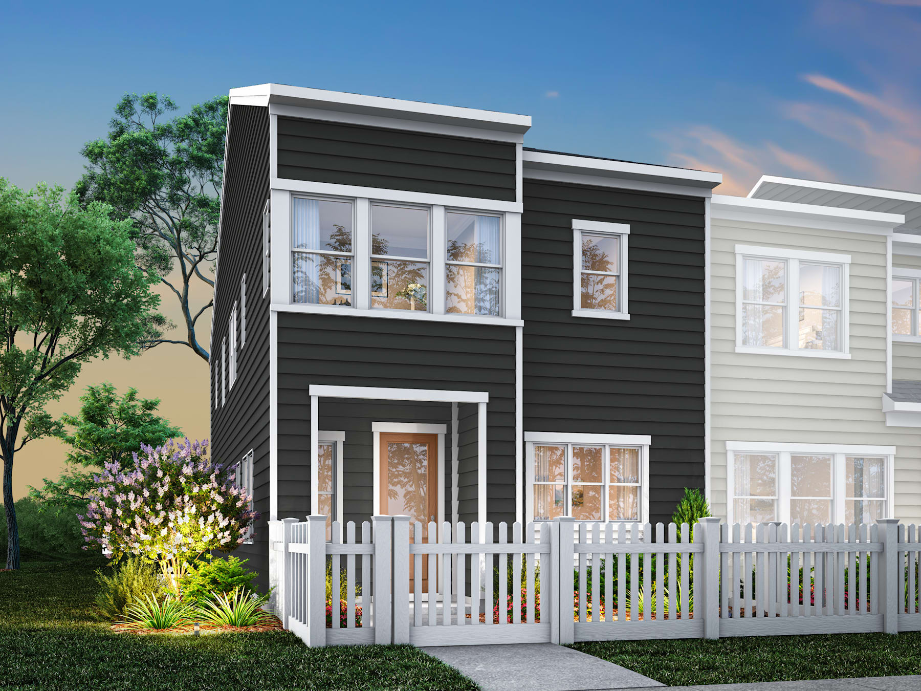 A modern two-story townhouse with a white picket fence and lush greenery in the foreground, set against a backdrop of a clear blue sky.