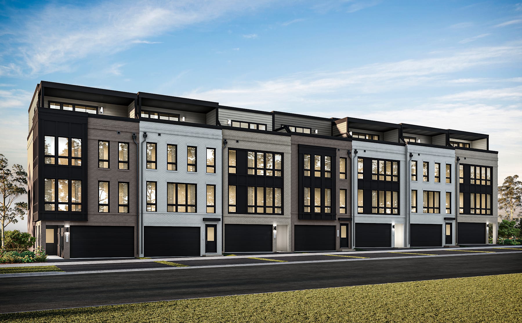 A modern multi-story residential building with a sleek, contemporary design stands against a backdrop of a clear blue sky with wispy clouds.