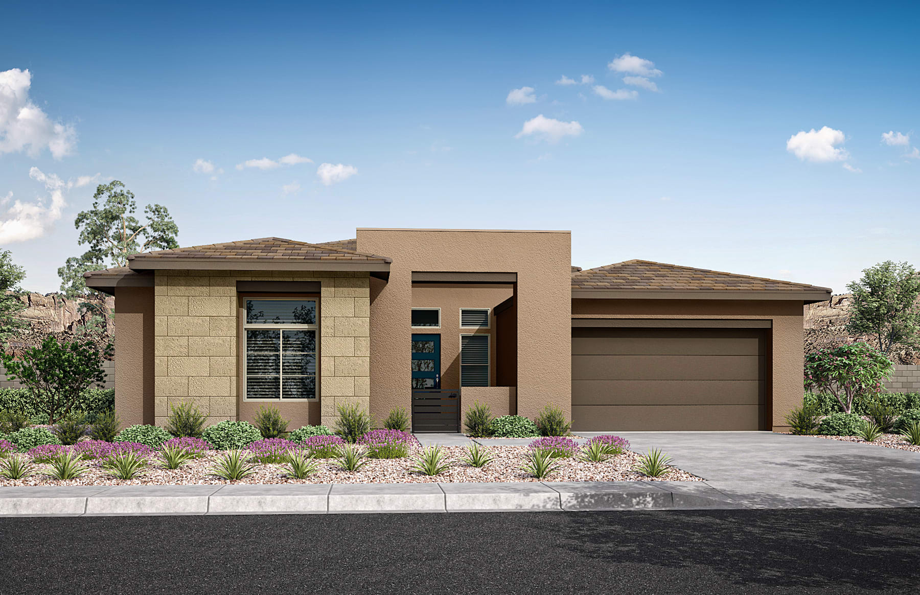 A modern, single-story house with a garage, surrounded by landscaped vegetation and a paved driveway, set against a clear blue sky with scattered clouds.