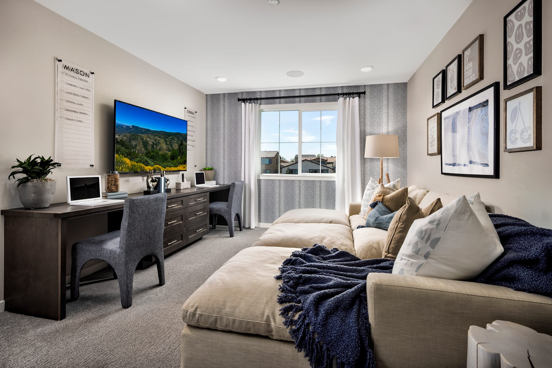 A cozy and well-furnished bedroom with a large window overlooking a scenic landscape, featuring a comfortable sofa, a television, and various decorative elements.