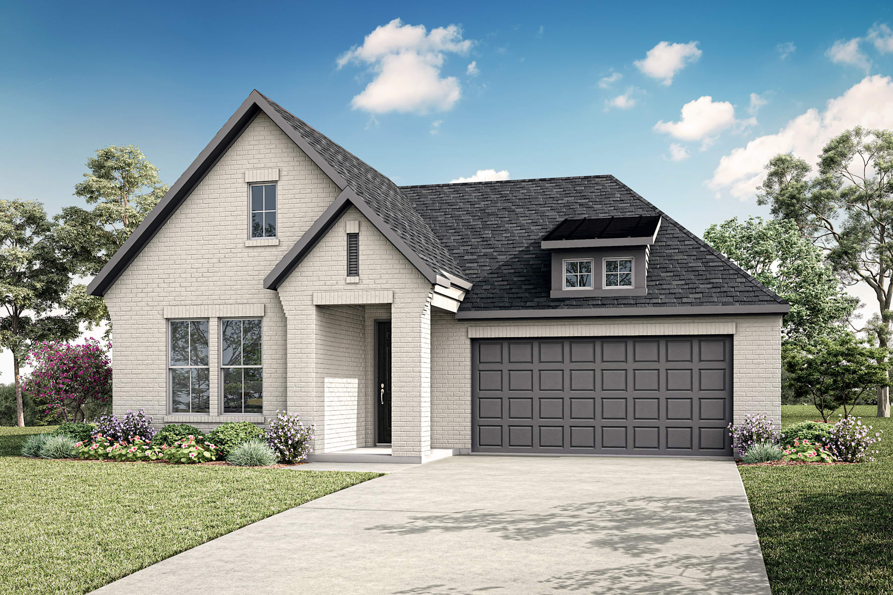 A charming two-story house with a gray exterior, a gabled roof, and a garage door stands in a well-manicured yard surrounded by lush greenery and blooming flowers under a bright, cloudy sky.