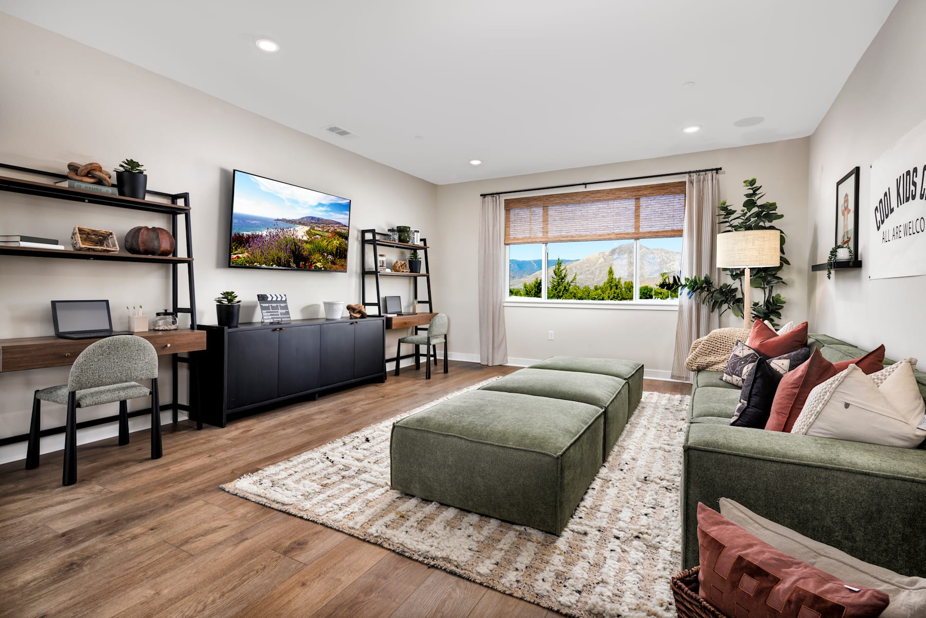 A cozy and well-furnished living room with a large window overlooking a scenic outdoor landscape.