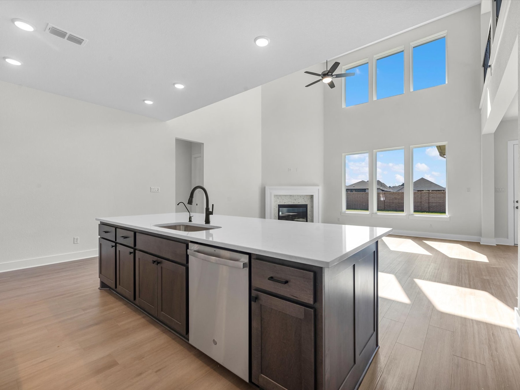 A modern, open-concept kitchen with a large island, stainless steel appliances, and ample natural light streaming in through the windows.