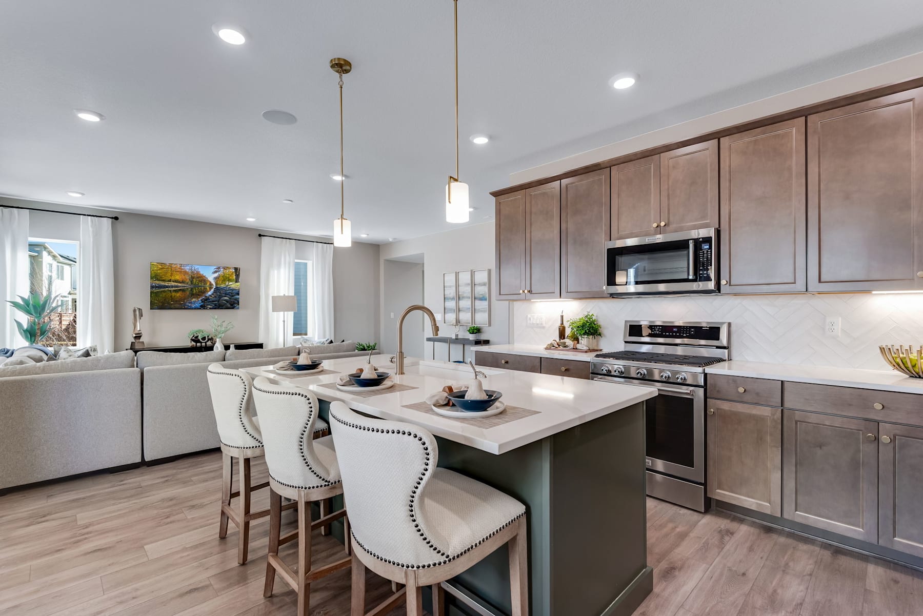 A modern and well-designed kitchen with wooden cabinets, a central island, and various appliances and decor elements, creating a warm and inviting atmosphere.