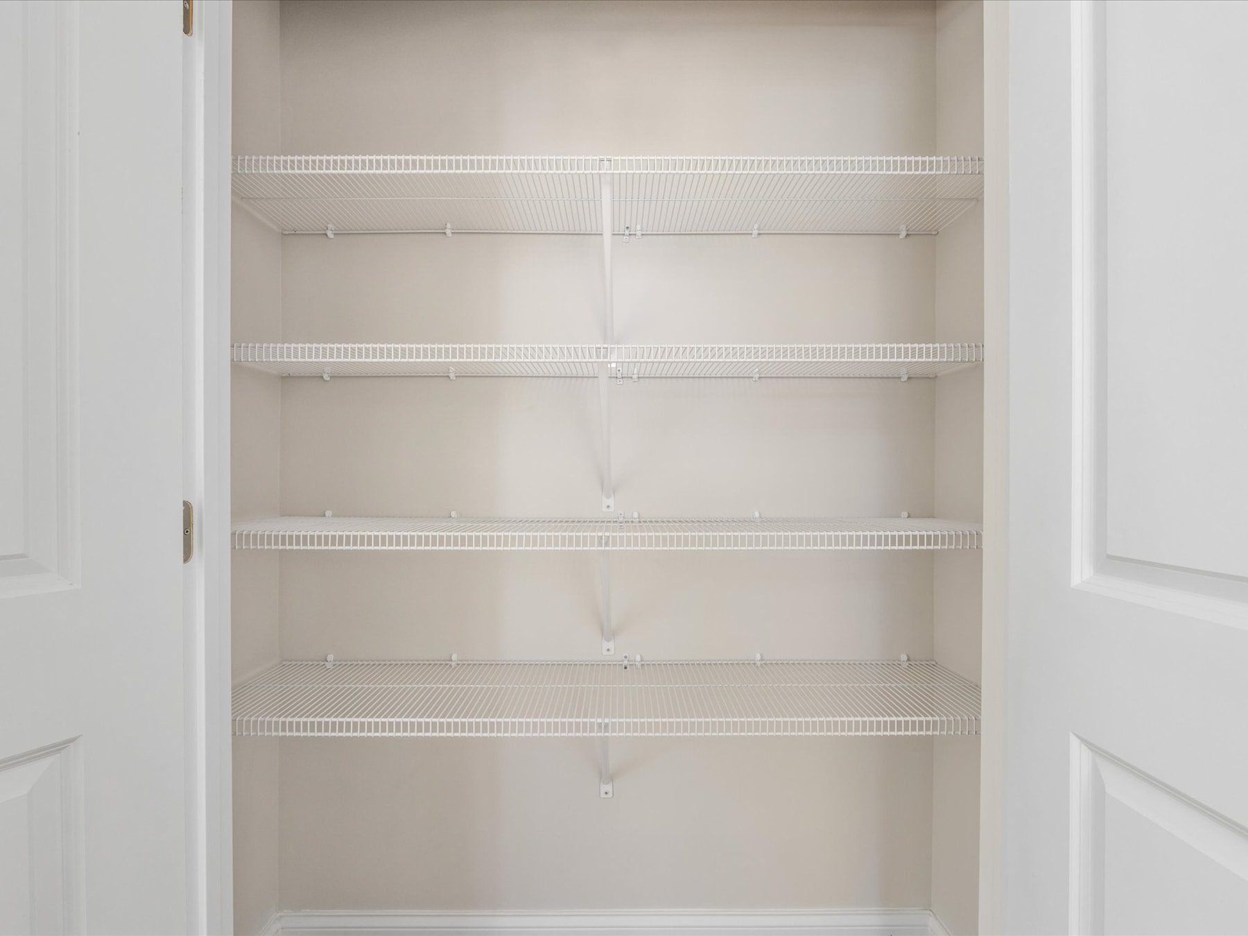 An empty white shelving unit with multiple shelves, providing a clean and organized storage space.