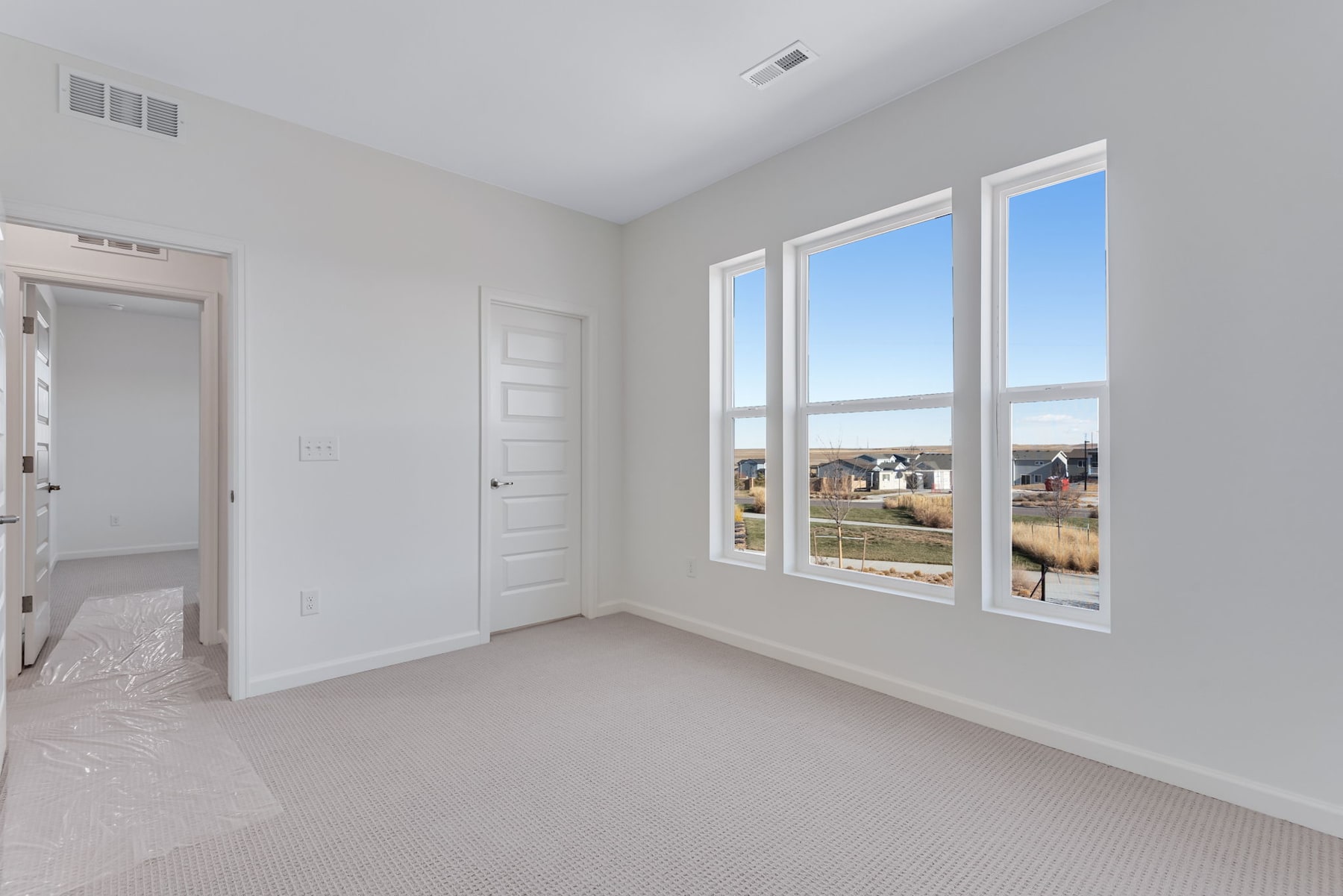 A bright, spacious room with large windows overlooking a scenic outdoor landscape.