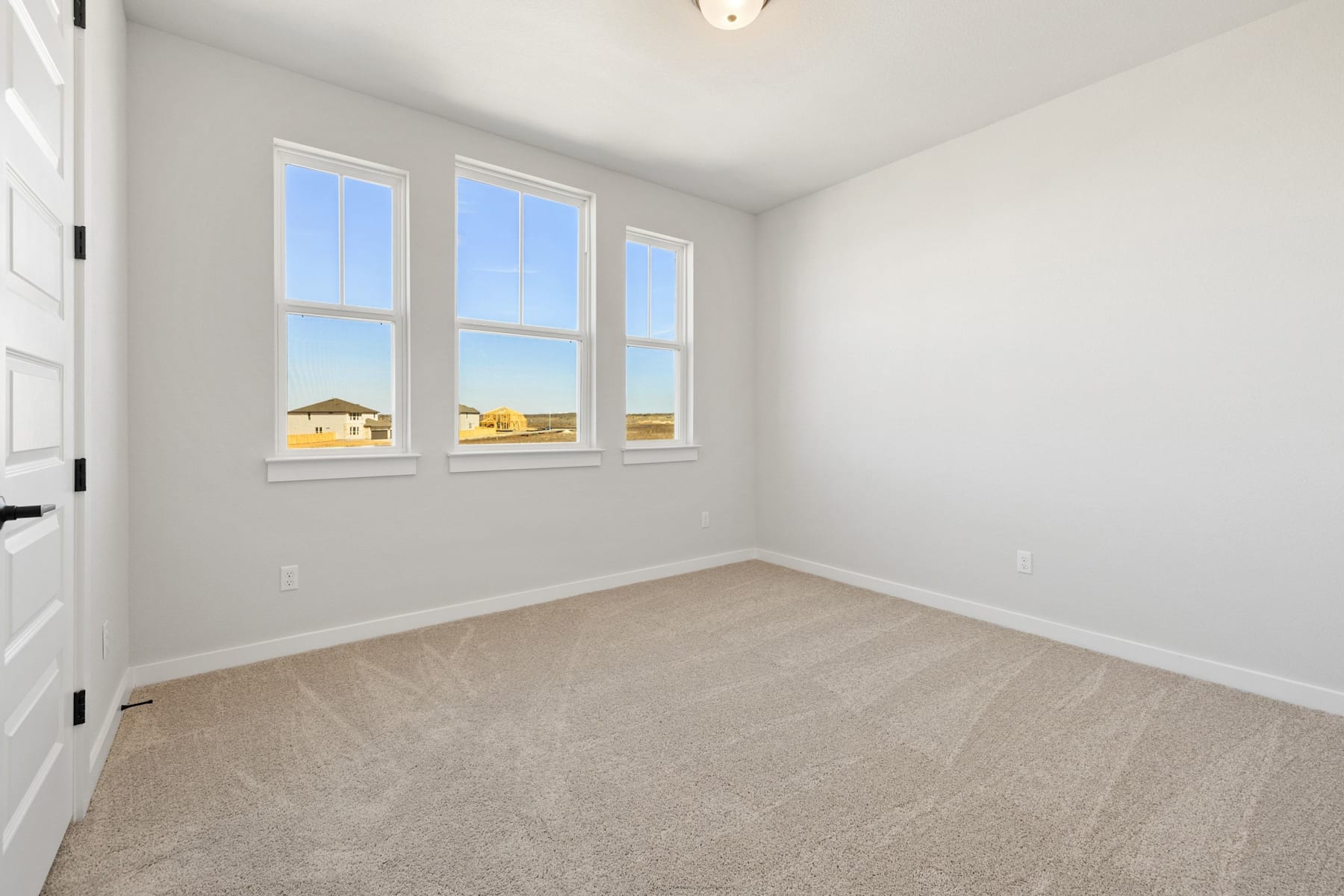 A bright and spacious room with large windows overlooking a scenic outdoor landscape.